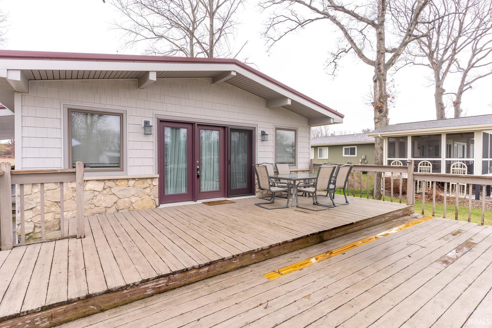 Wooden deck with outdoor dining area and french doors