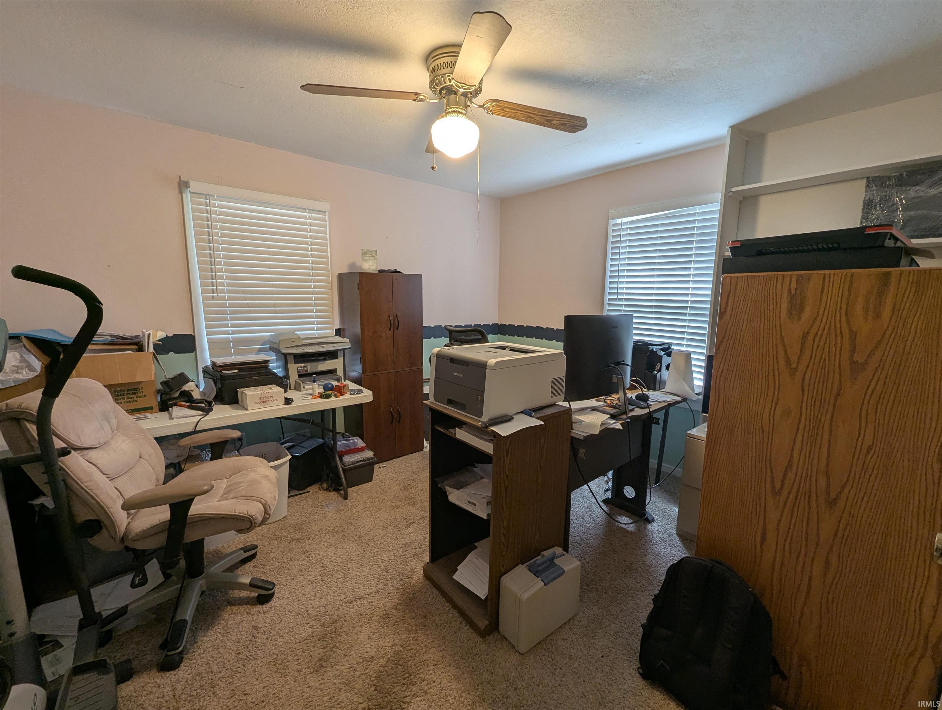 Office space with carpet and ceiling fan