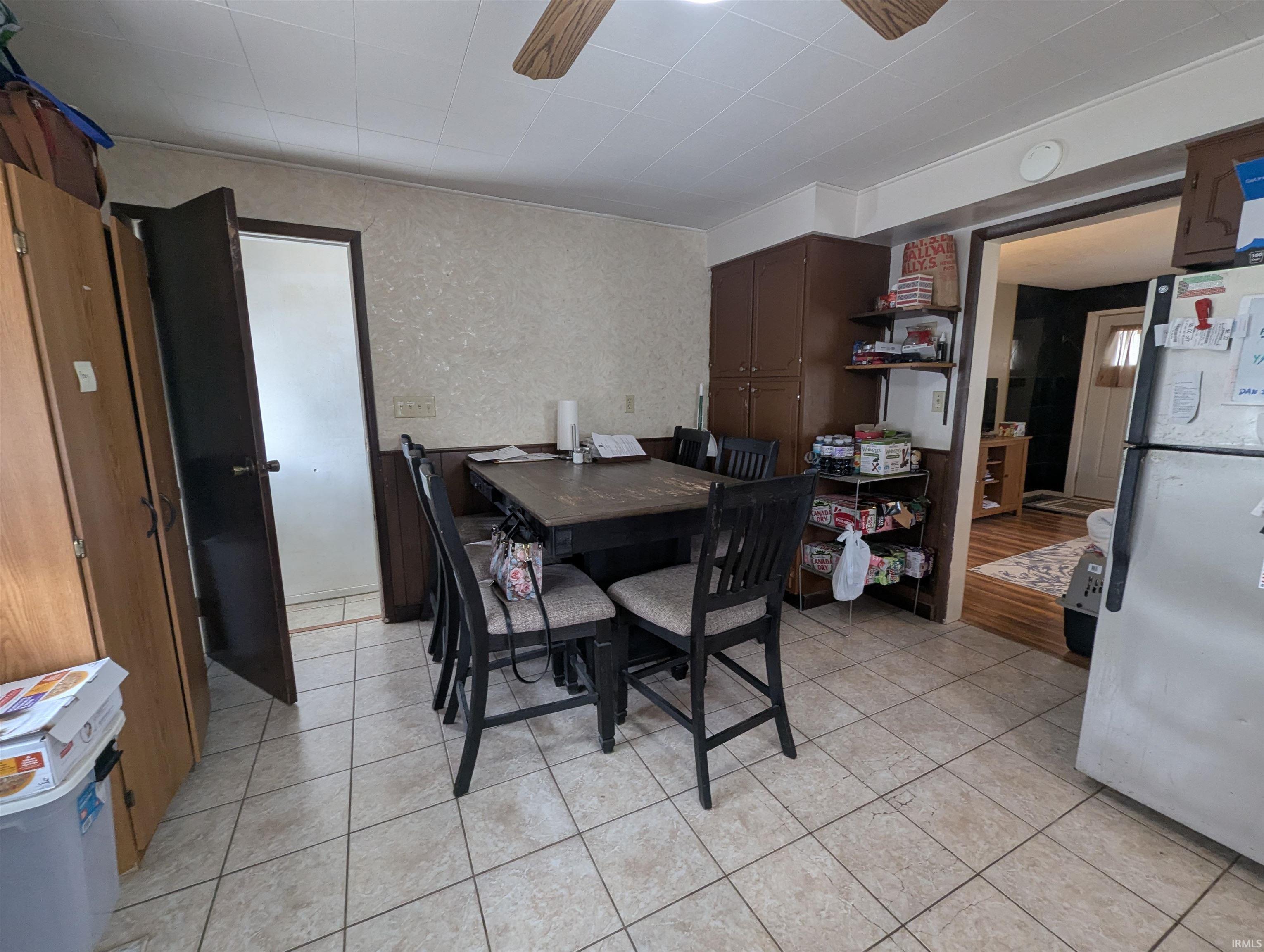 Dining space featuring a ceiling fan and light tile patterned floors