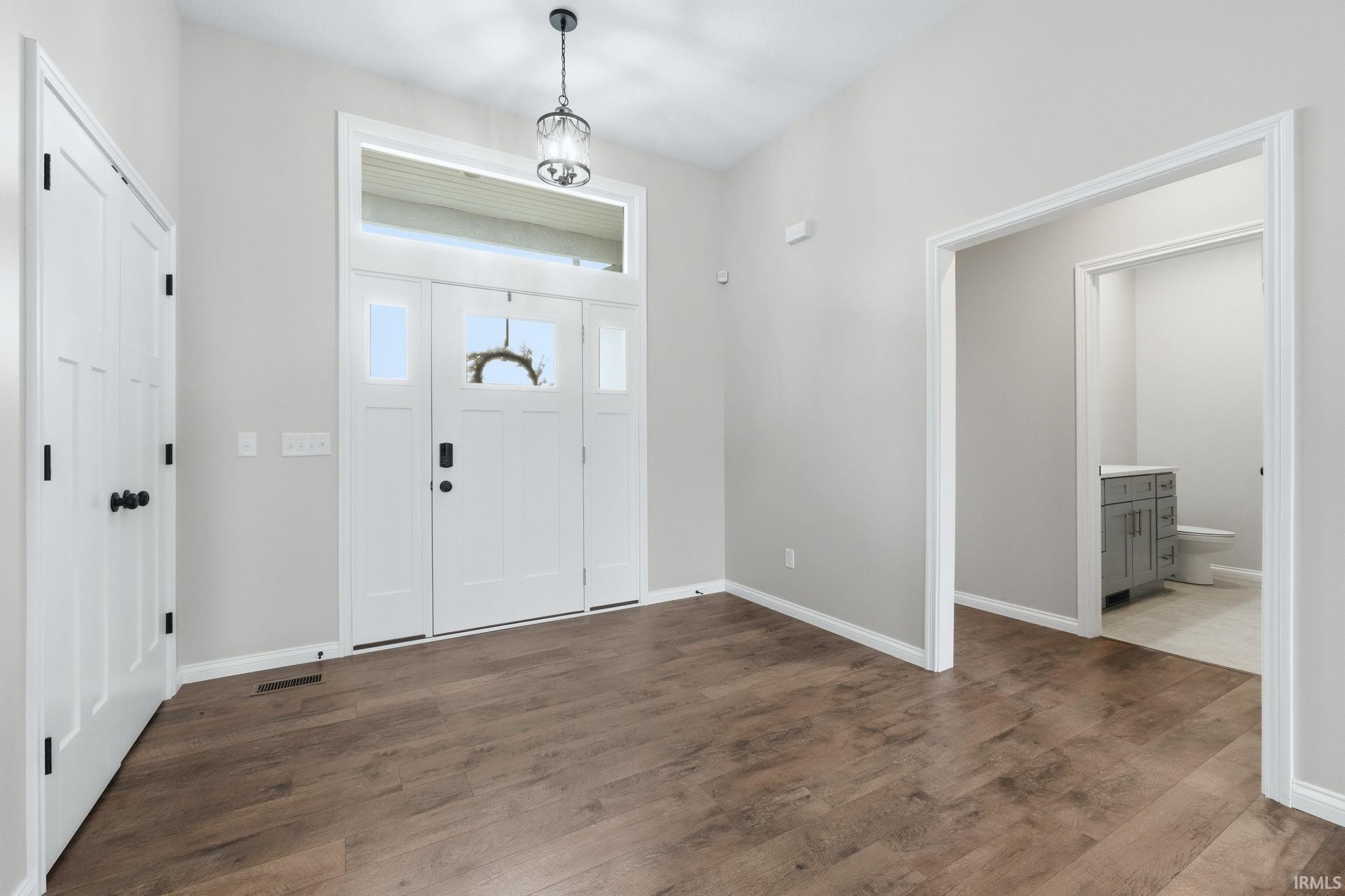 Entryway with dark wood-style floors