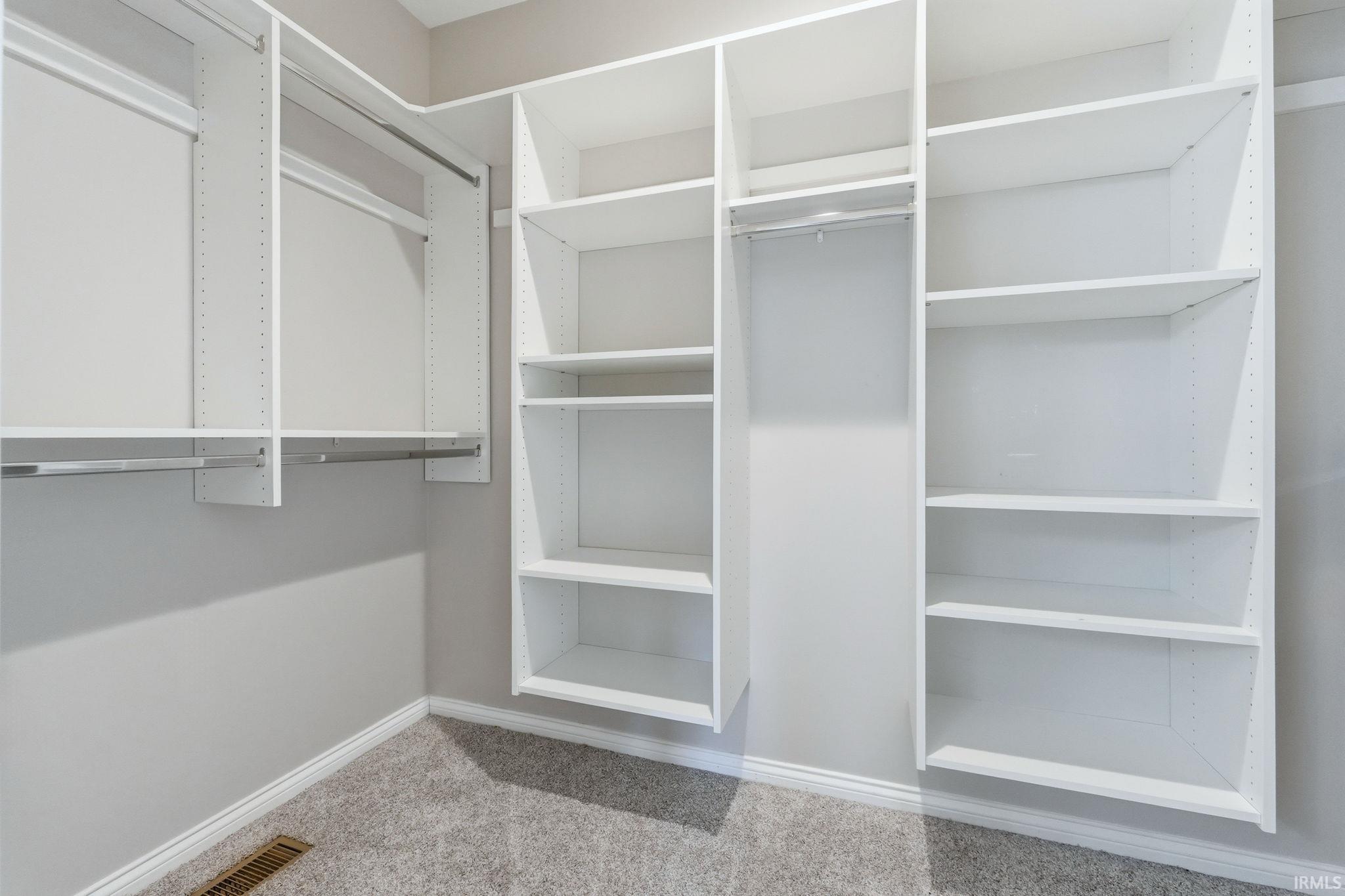 Walk in closet featuring light carpet
