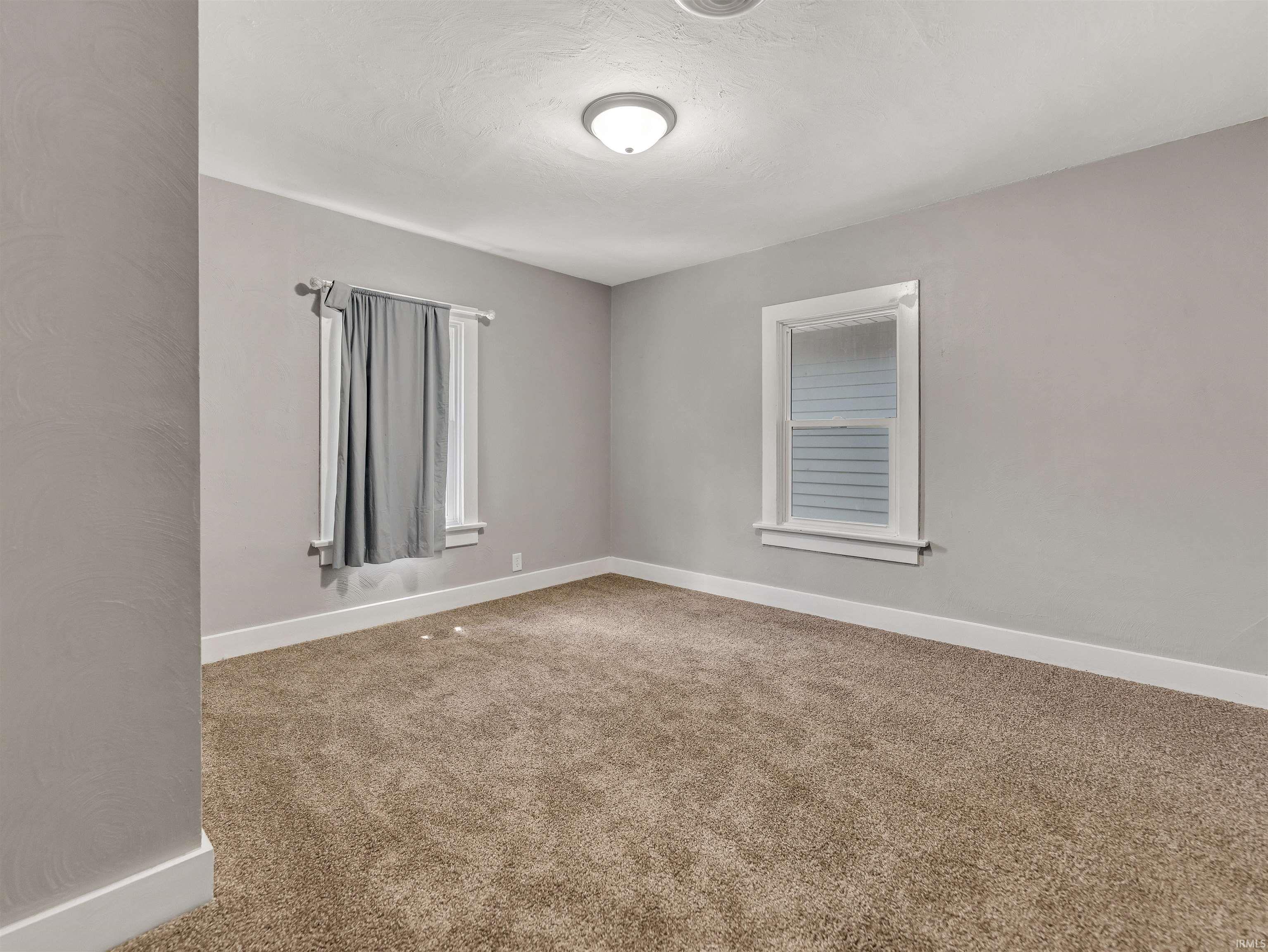 Neutral-toned carpeting paired with light grey walls and white trim