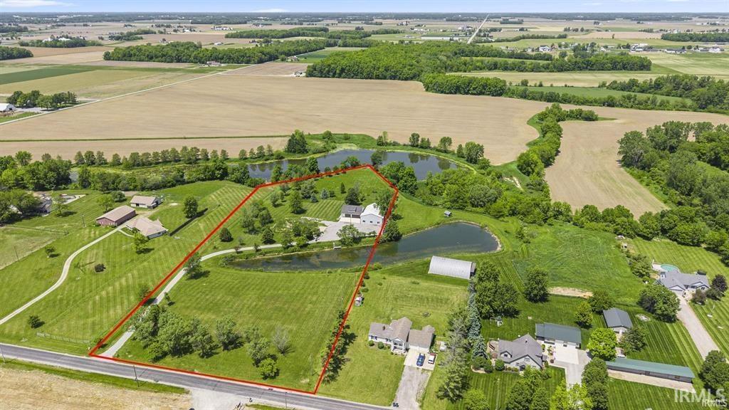 Overview of rural landscape featuring rows of crops and property parcel outlined