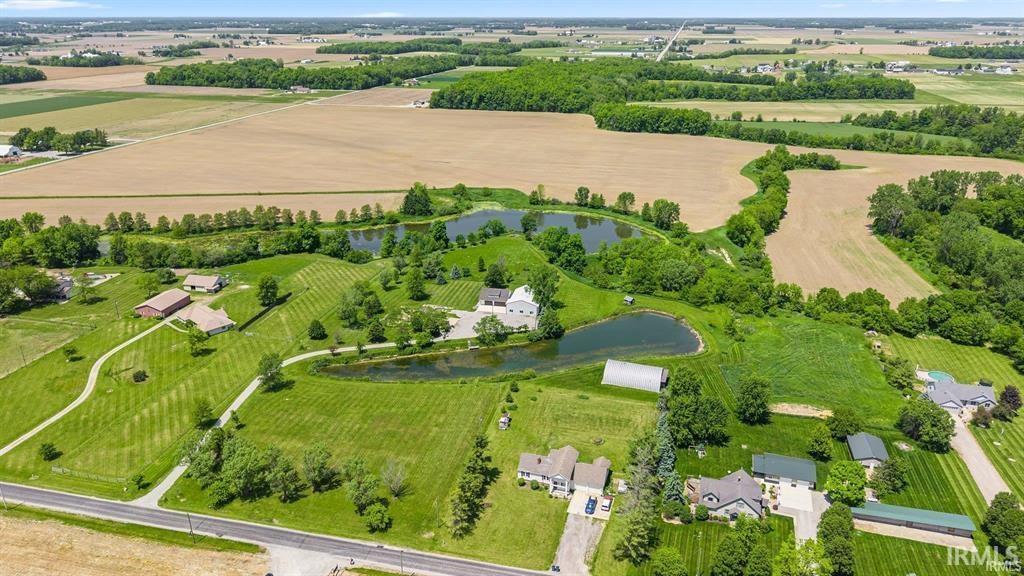View of rural area with rows of crops and a large body of water