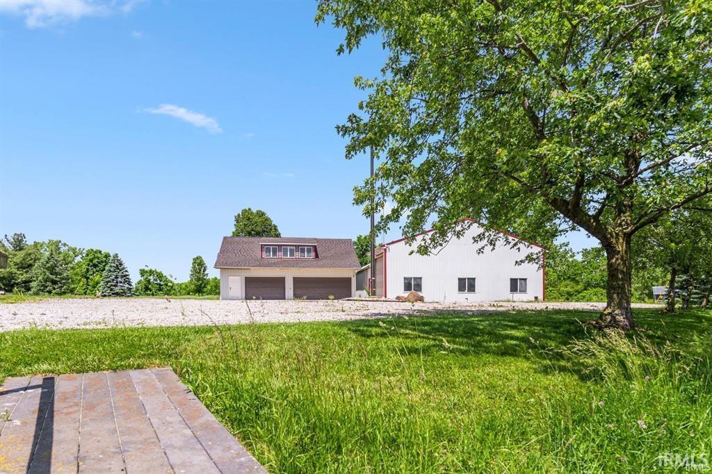 View of front of property with a garage and a front lawn