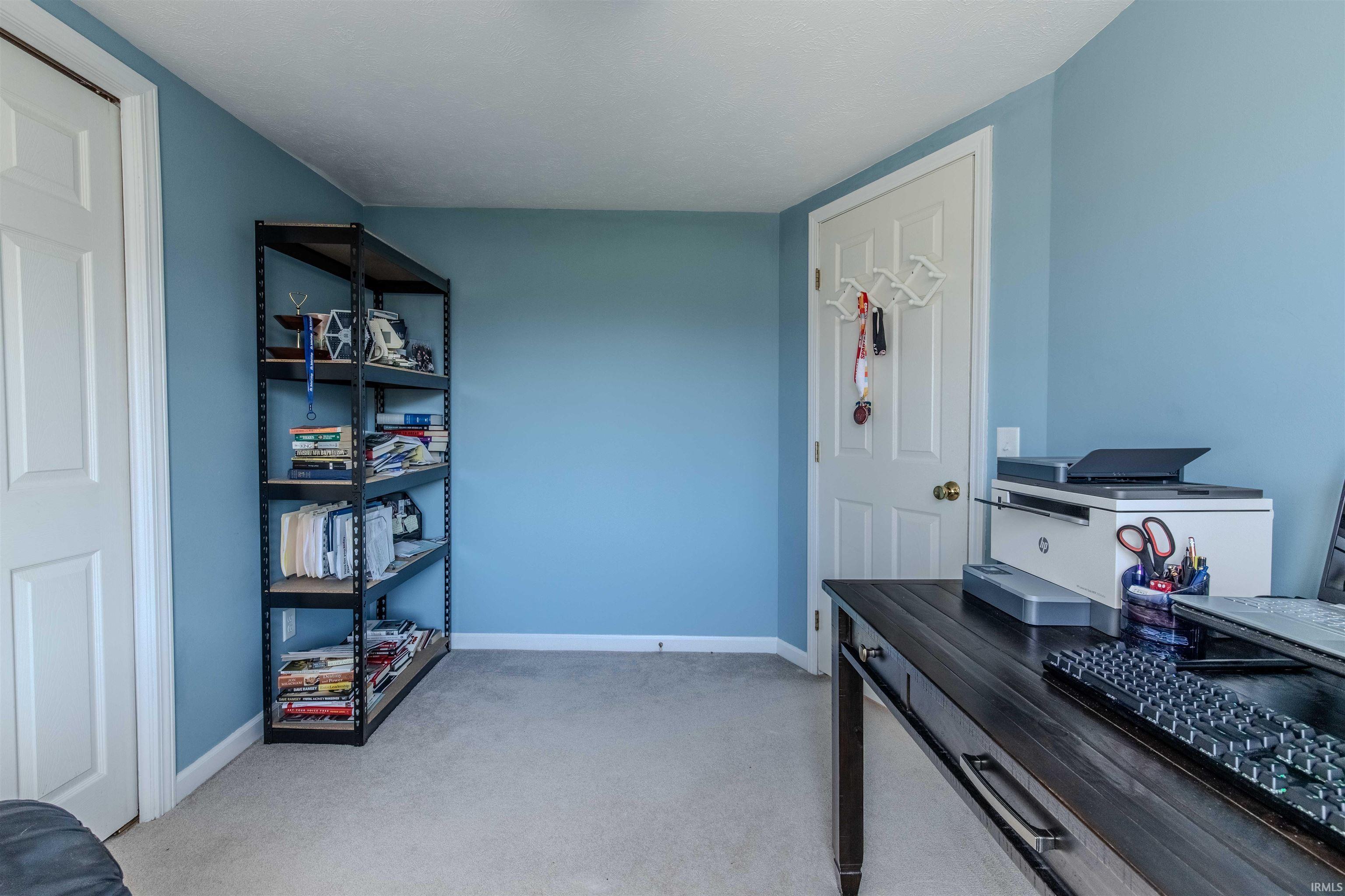 Office space with light carpet and baseboards