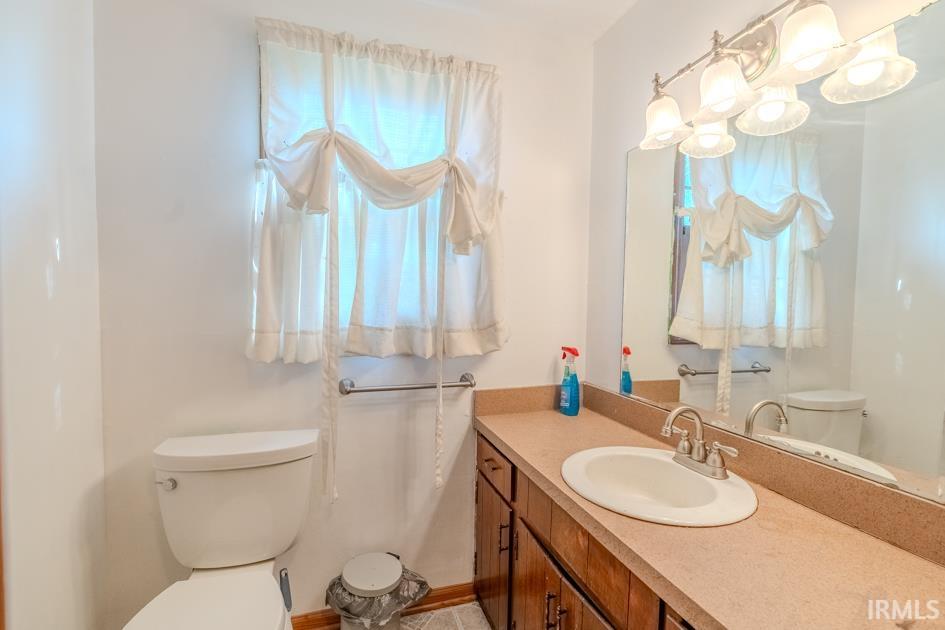 Half bath with vanity and plenty of natural light
