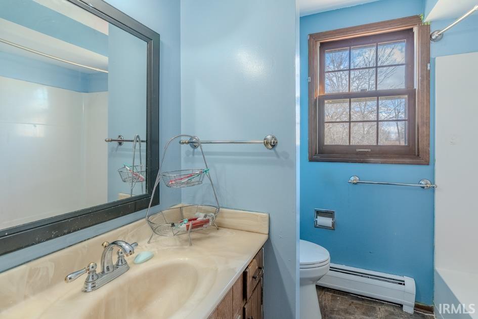Bathroom with a baseboard radiator and vanity