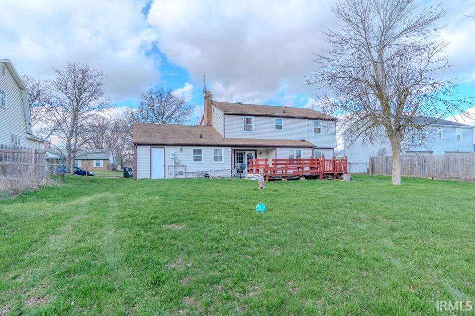 Back of property with a deck and a chimney