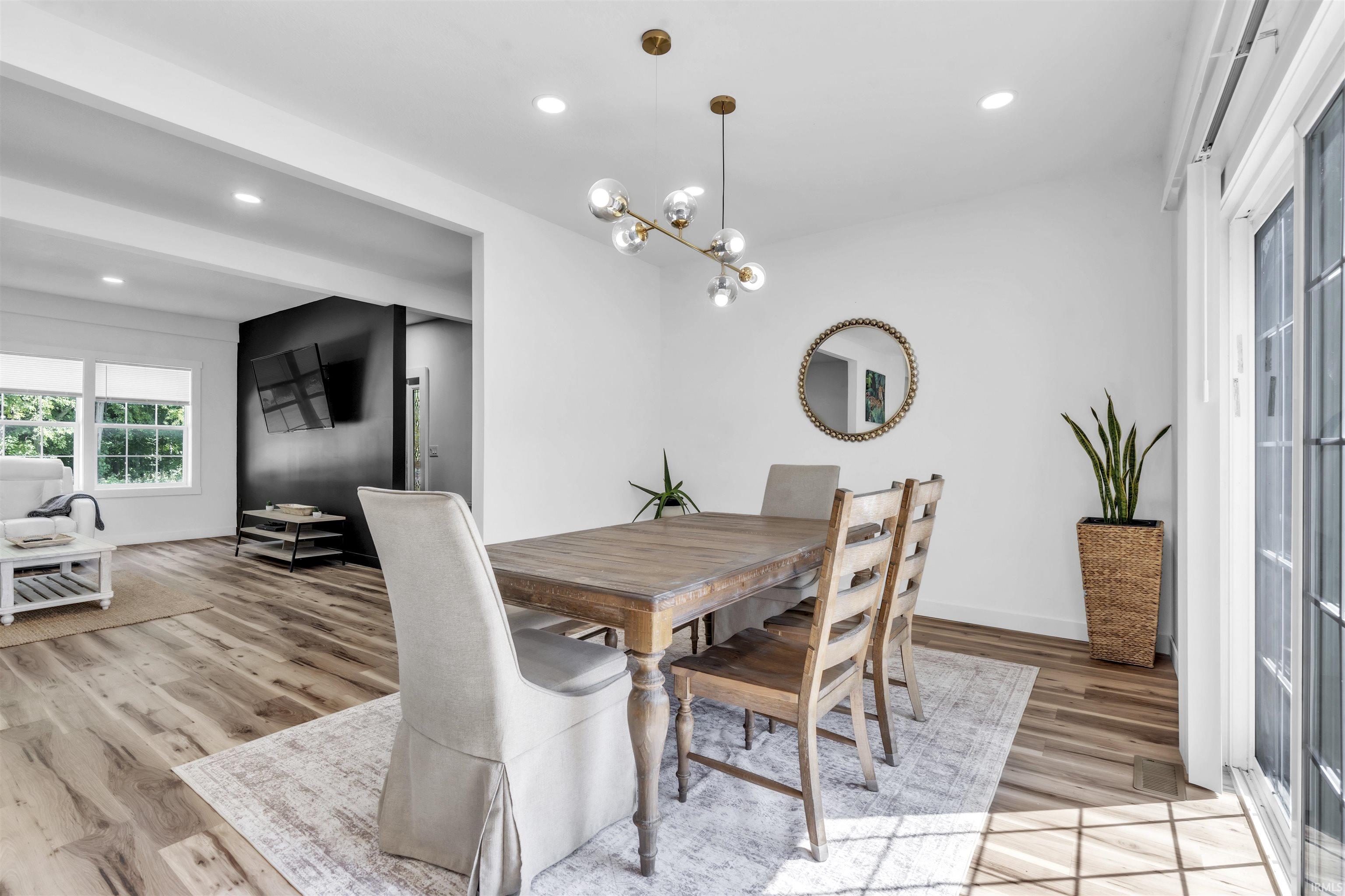 Dining space featuring light wood-style floors and hanging lights