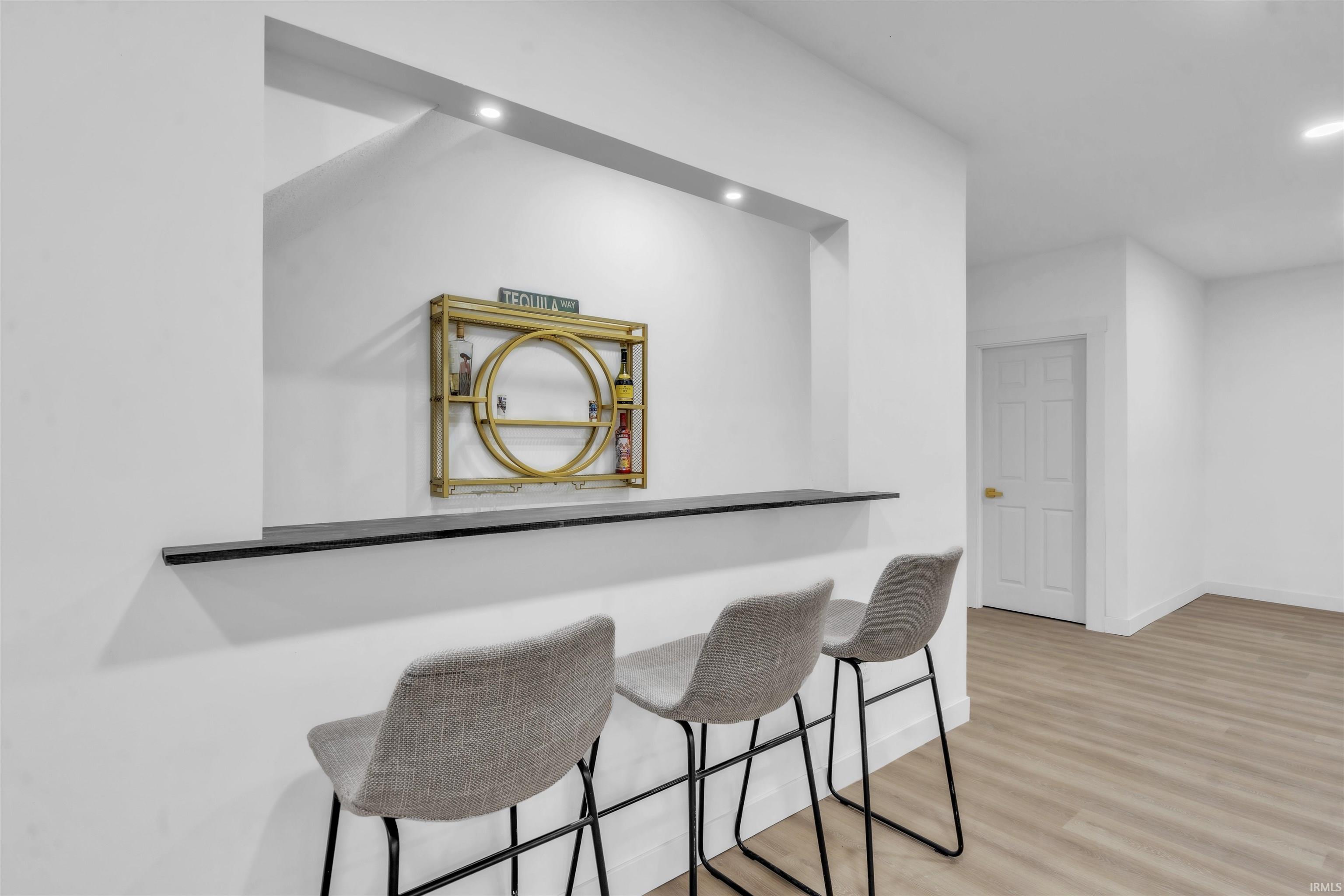 Bar with recessed lighting and light wood-style floors