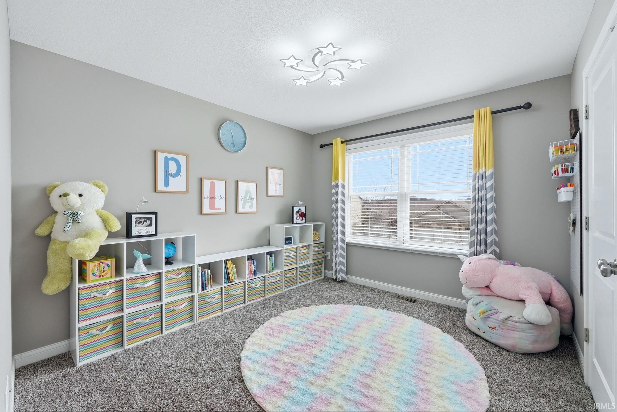 Rec room featuring baseboards and carpet floors