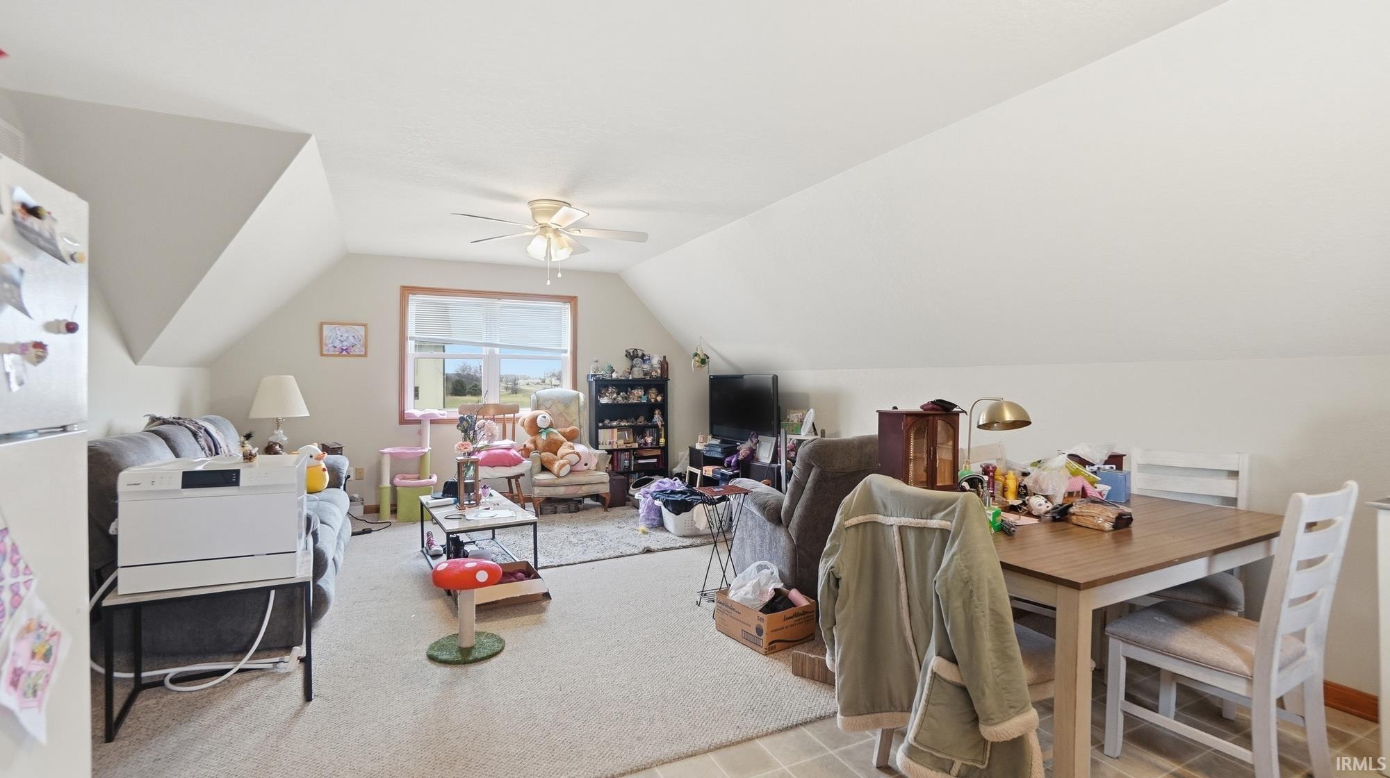 Dining space featuring lofted ceiling and a ceiling fan