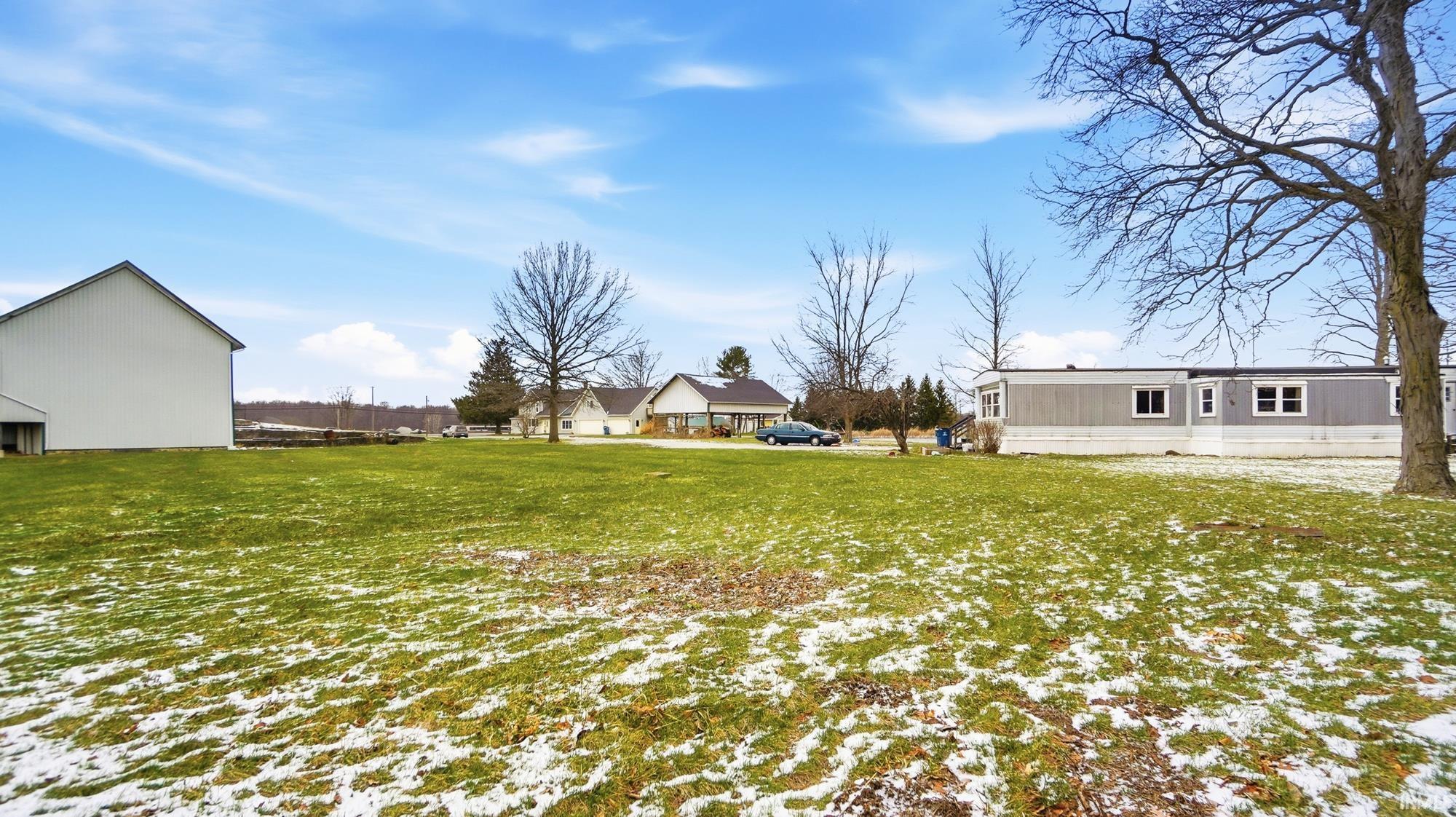 Yard covered in snow featuring a yard