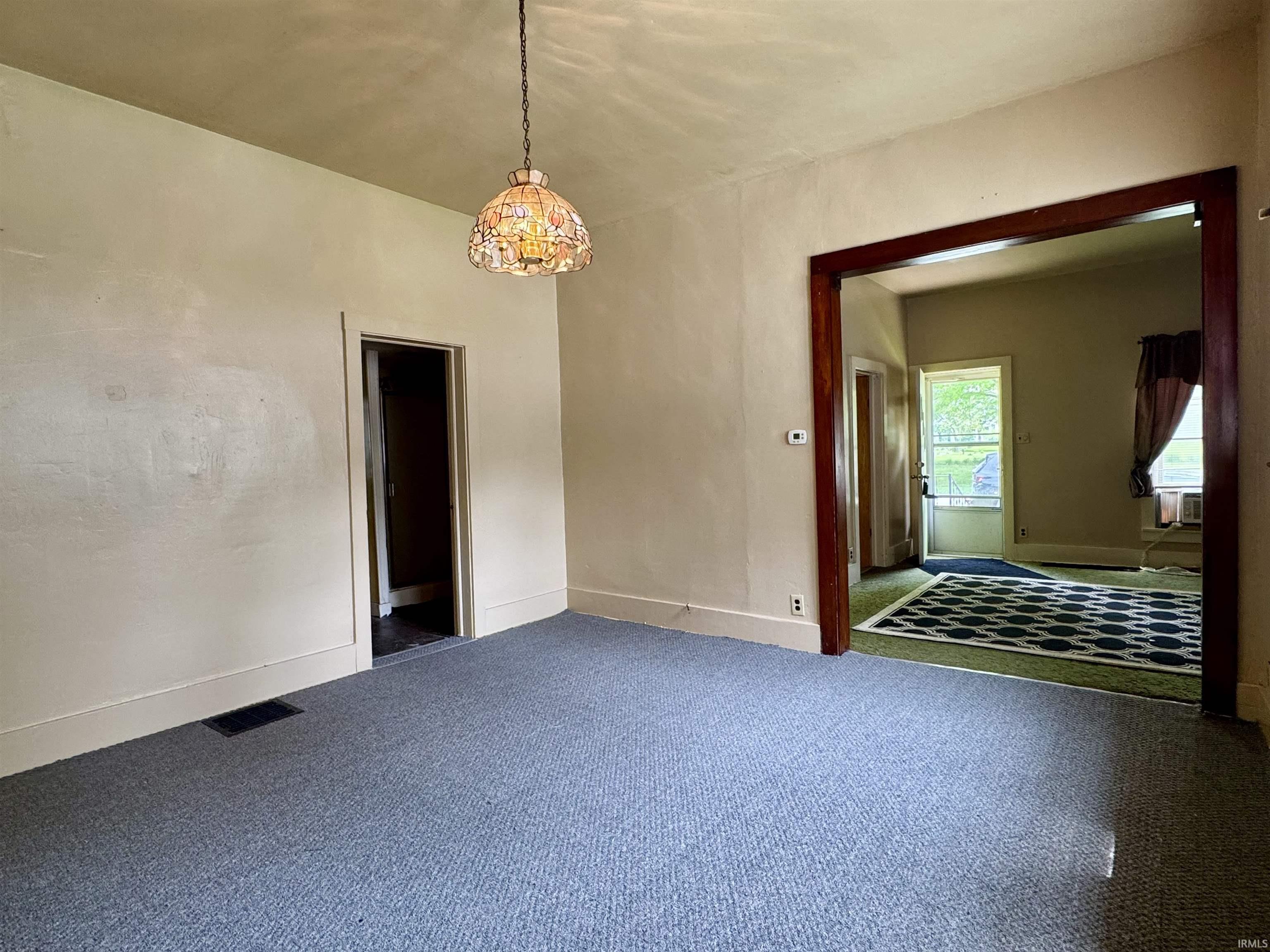 Room featuring light-colored walls and grey carpet flooring