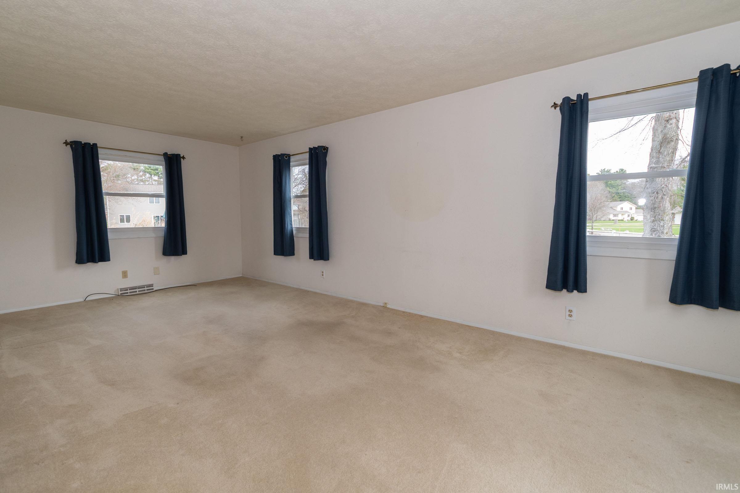 Unfurnished room with carpet flooring