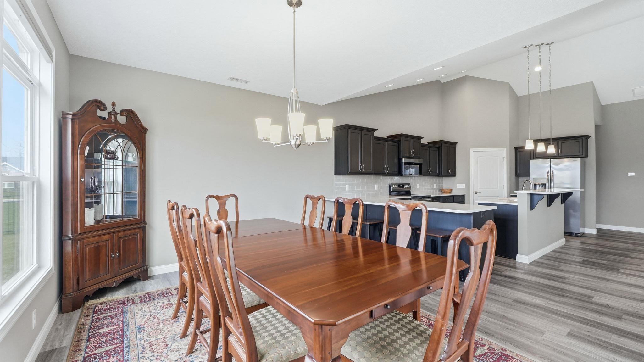 Dining space featuring light a chandelier and lofted ceiling