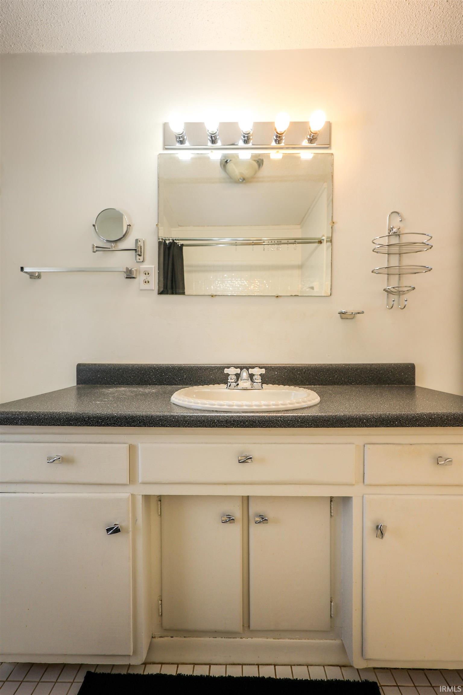 Bathroom featuring vanity and a shower with curtain