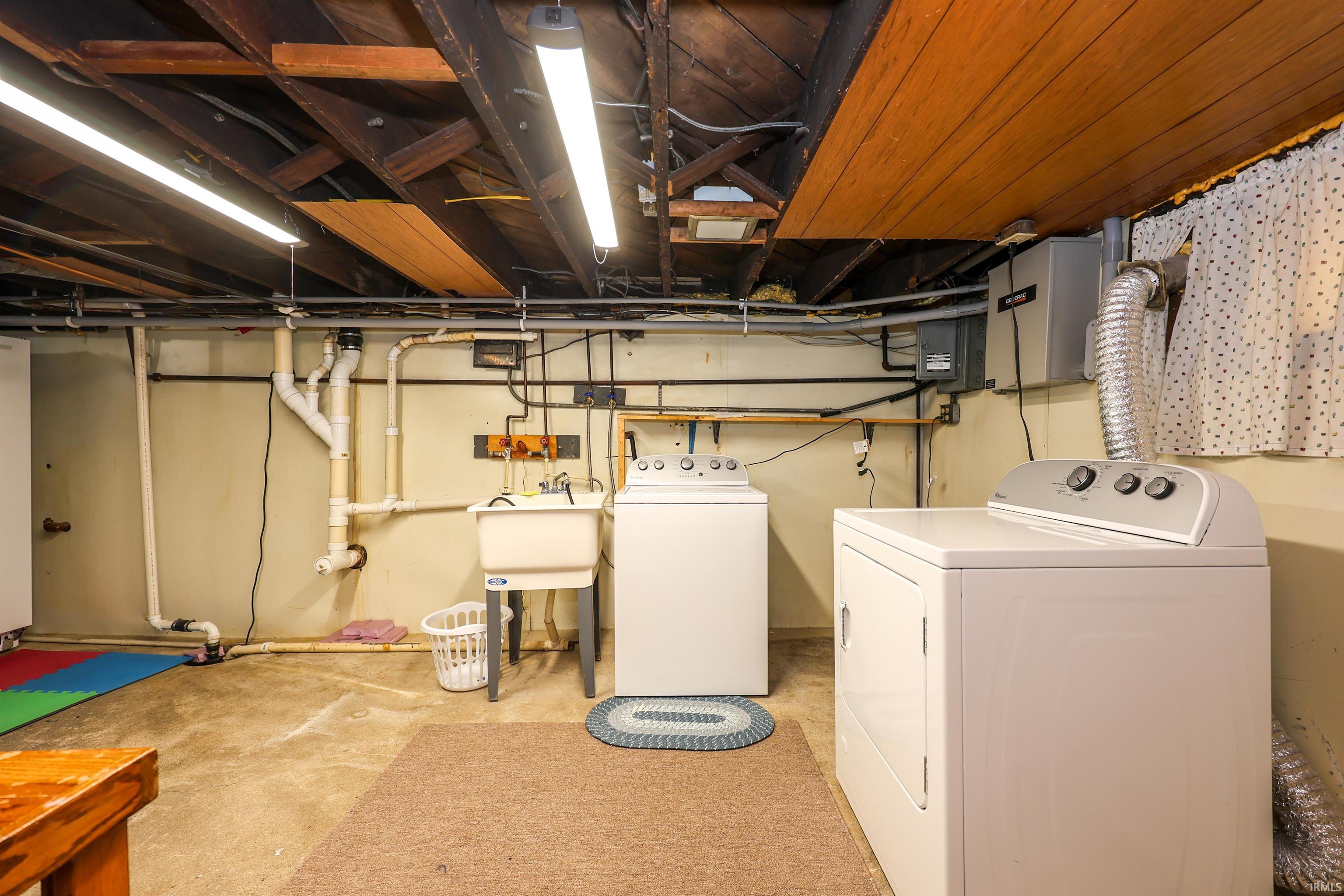 Unfinished below grade area with separate washer and dryer