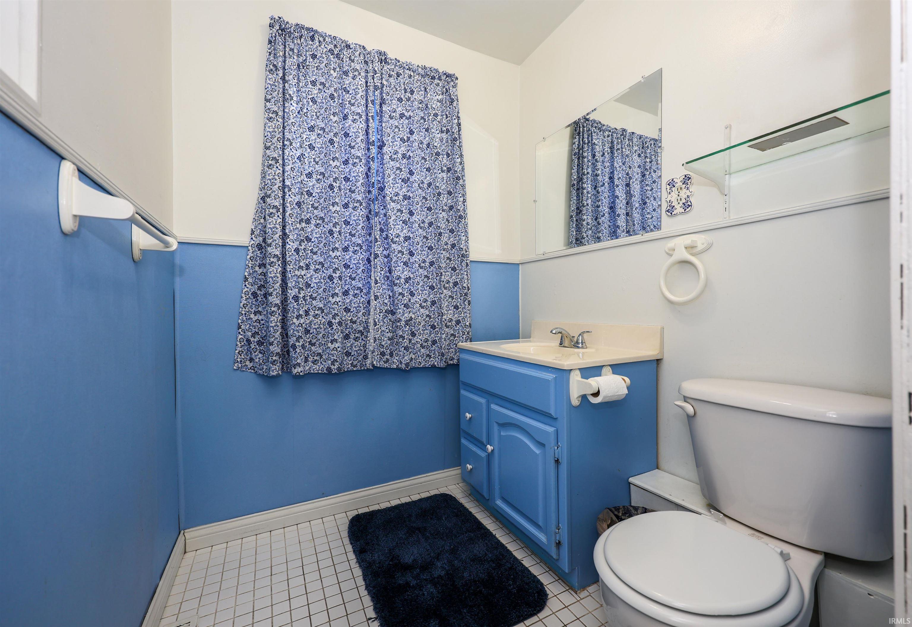 Bathroom with vanity and light tile patterned floors