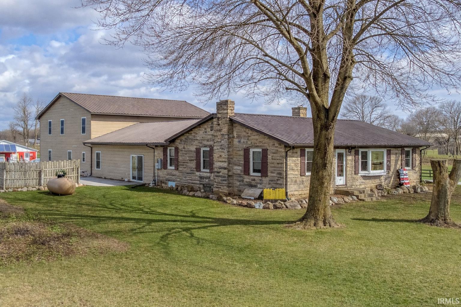 Rear view of house with a chimney and a patio area