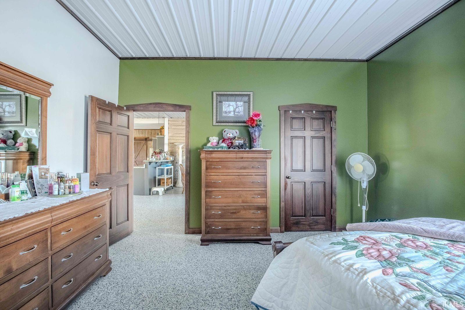 Bedroom featuring light carpet