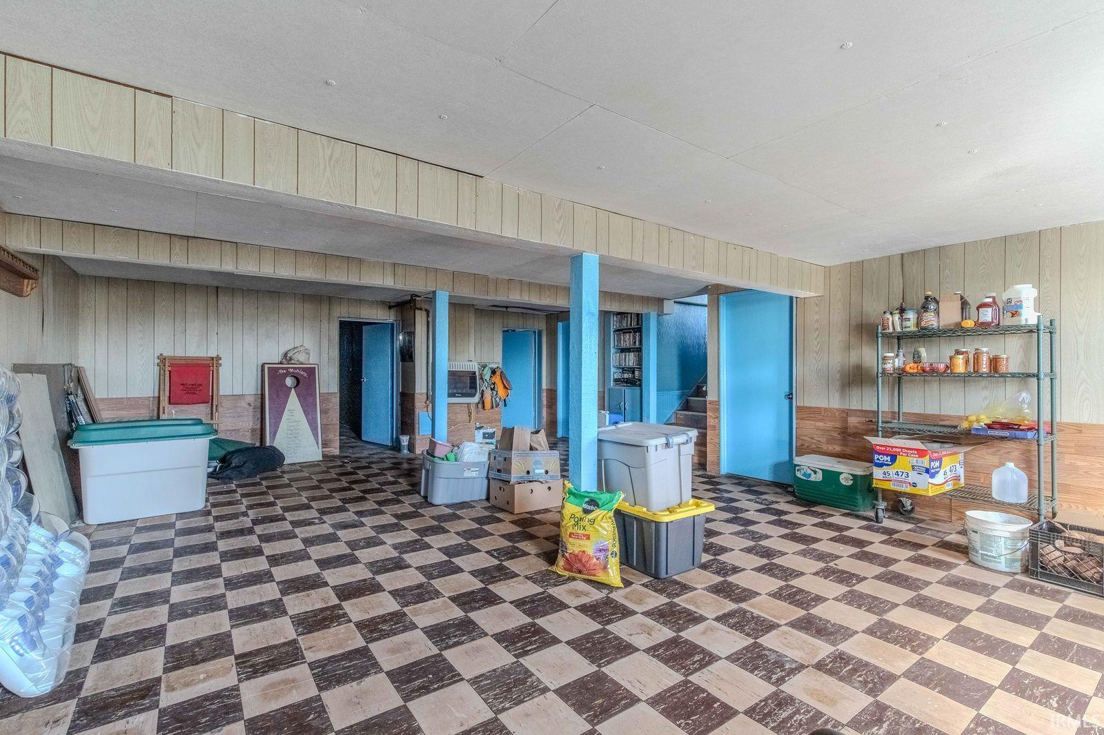 Finished basement with wood walls and dark flooring