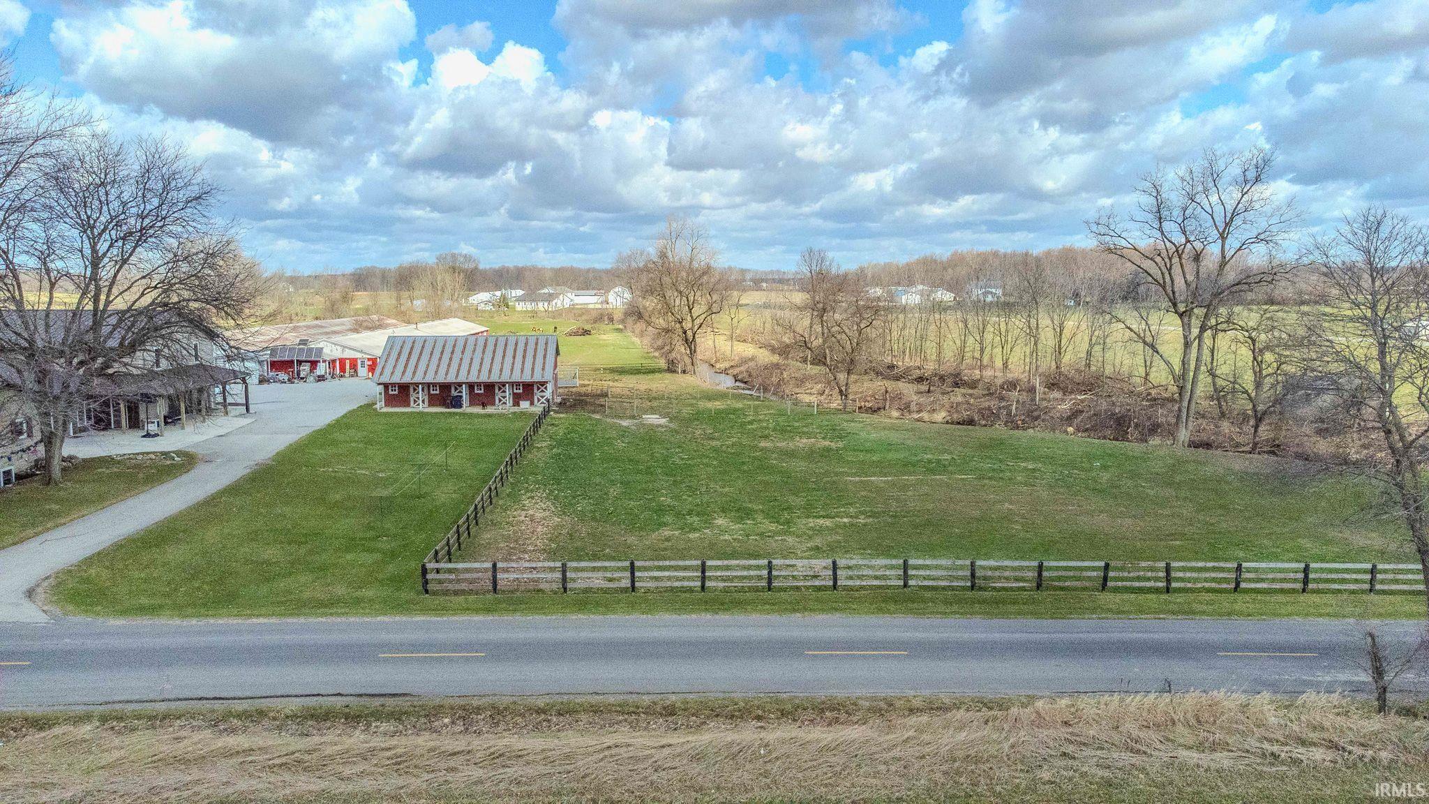 View of yard featuring a view of rural / pastoral area and an outdoor structure