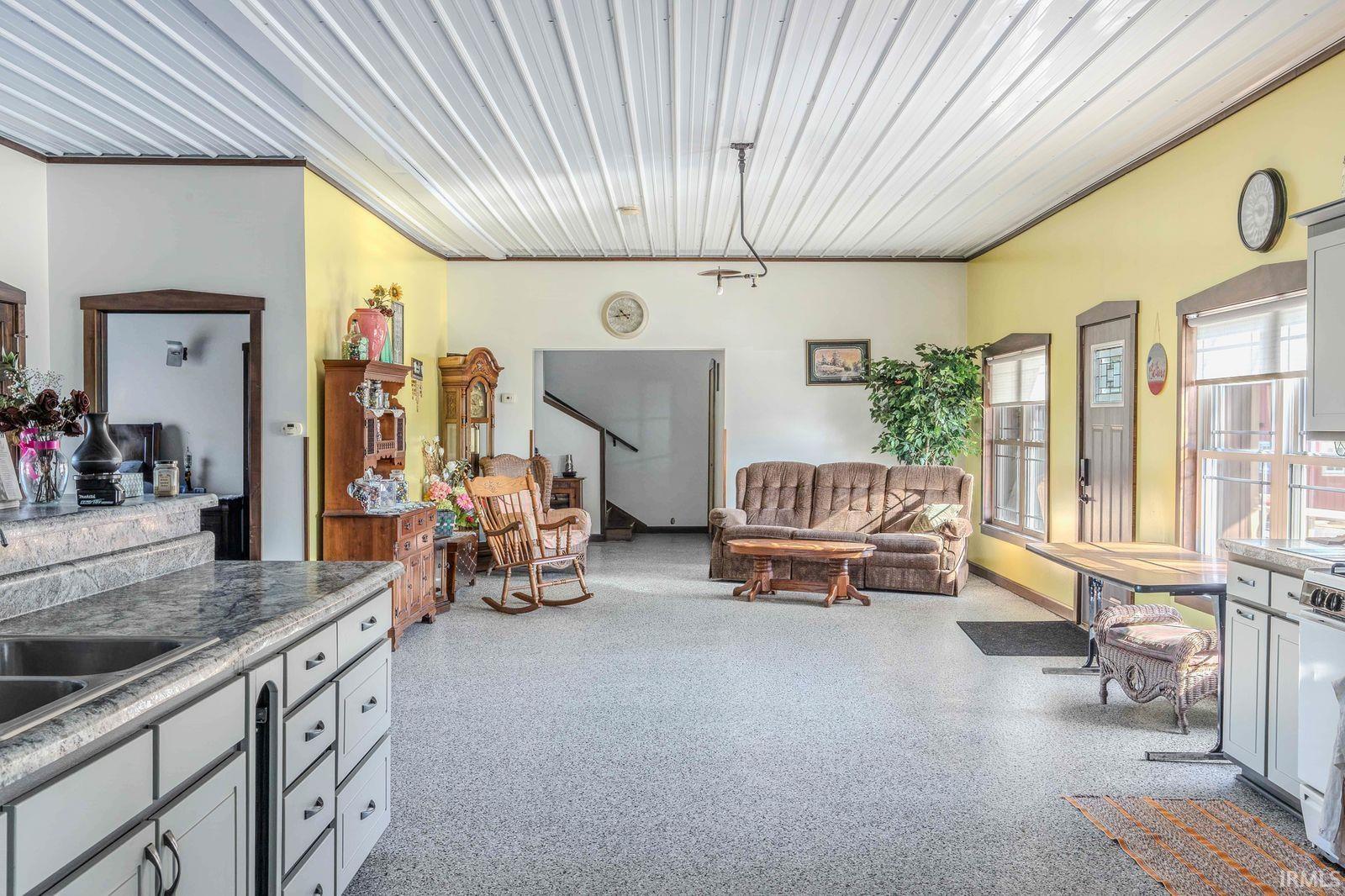Living room featuring dark aggregate flooring
