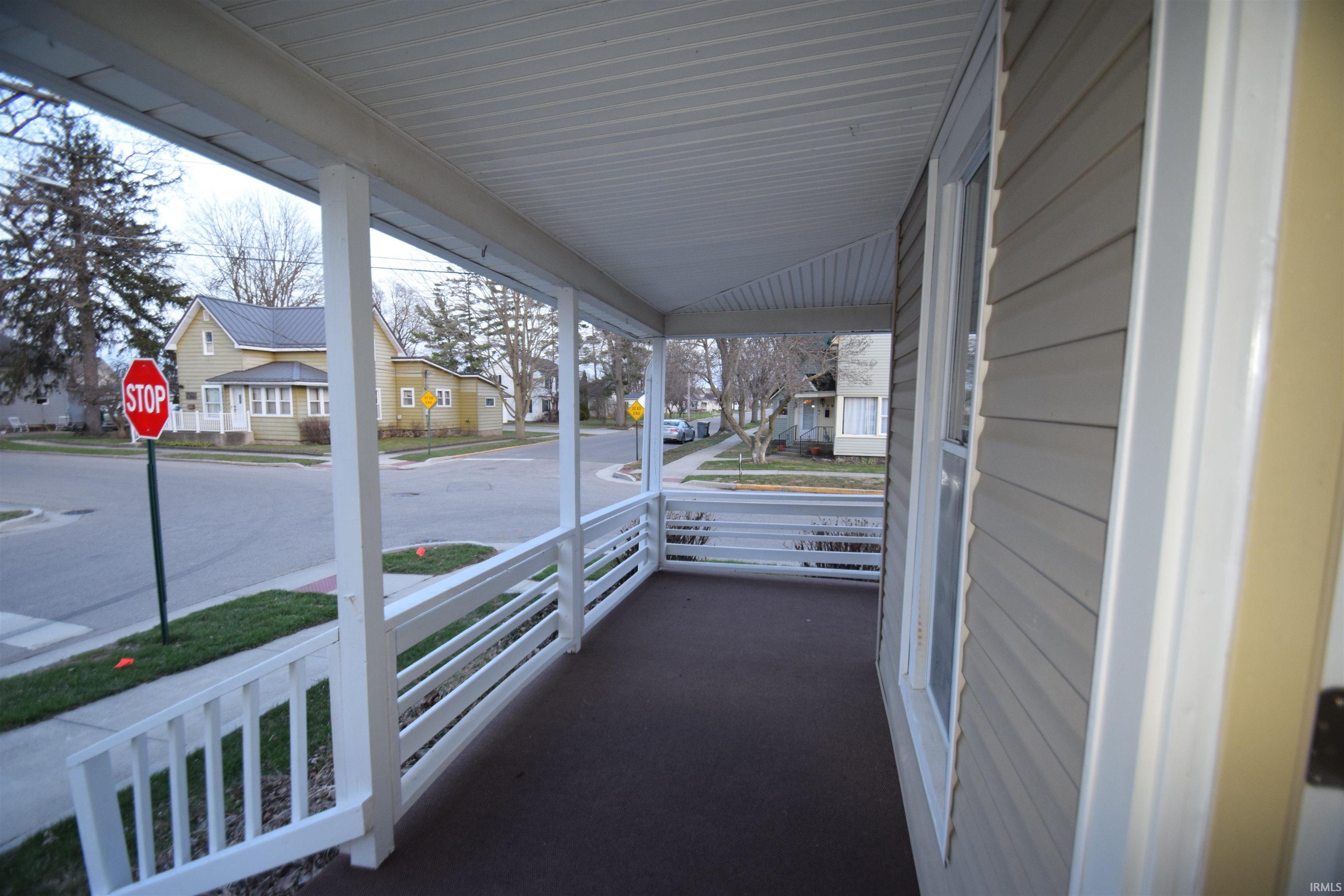 Covered porch with a residential view