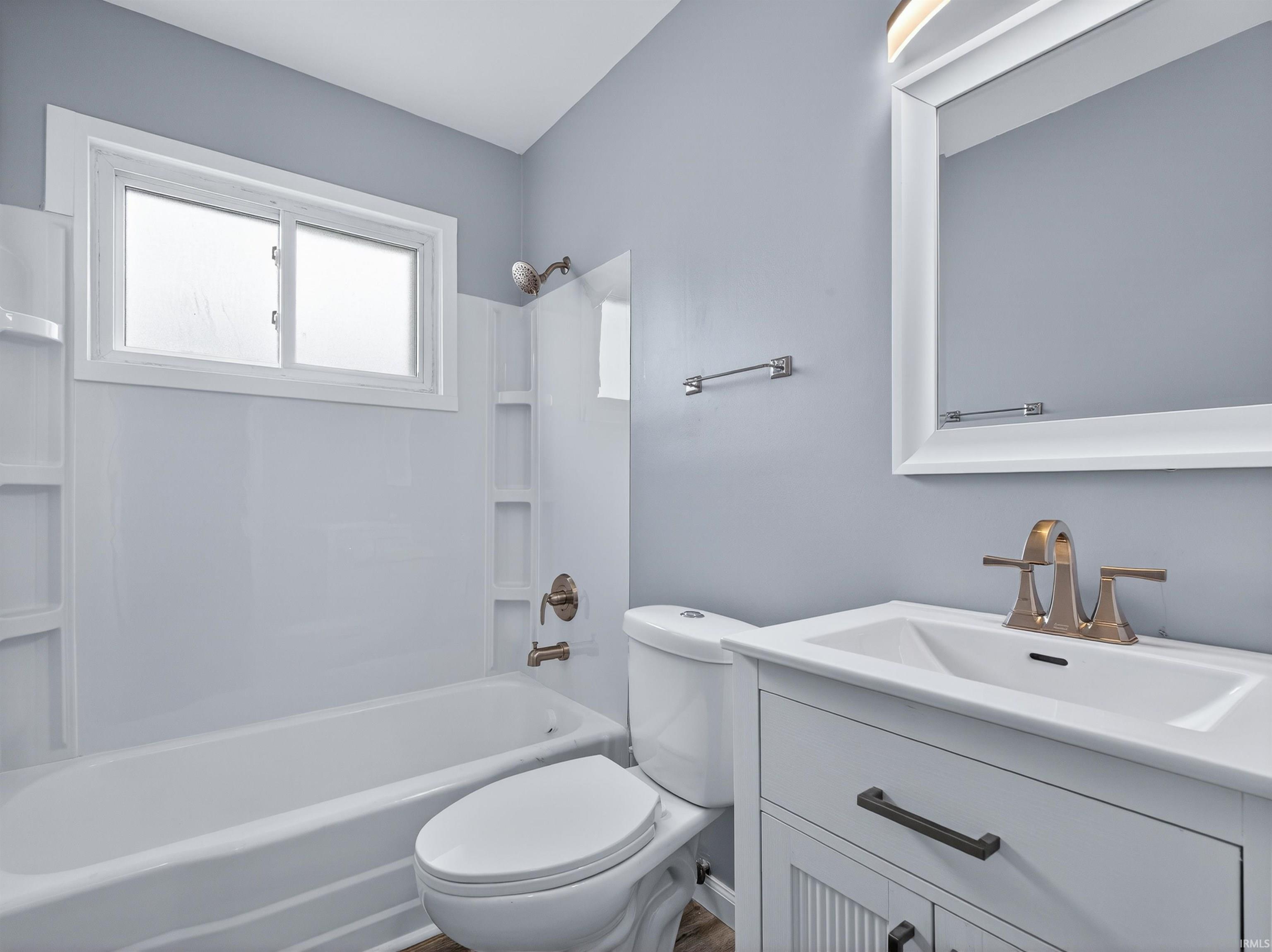 Bathroom with vanity and shower / washtub combination