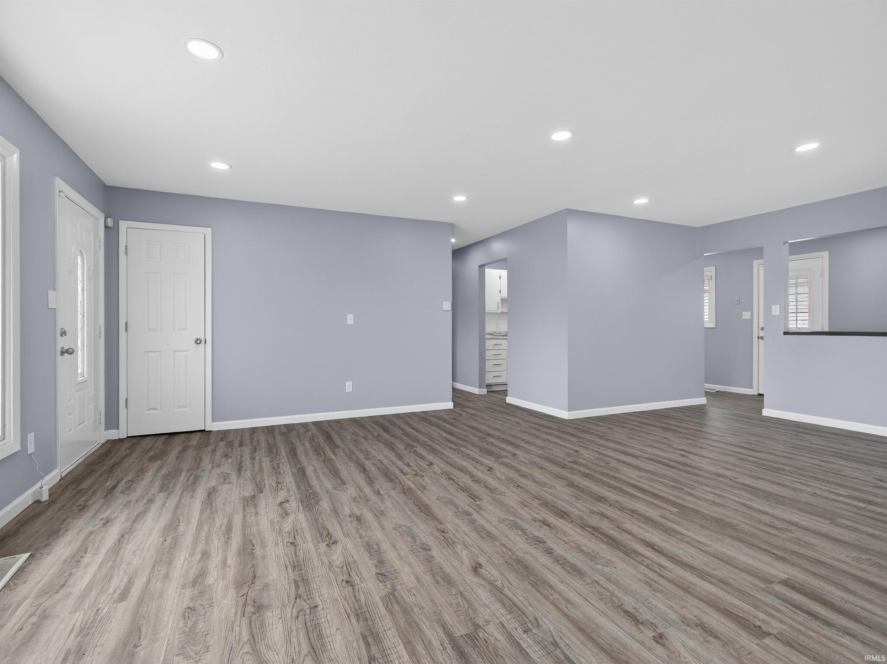 Unfurnished living room featuring light wood-type flooring and recessed lighting