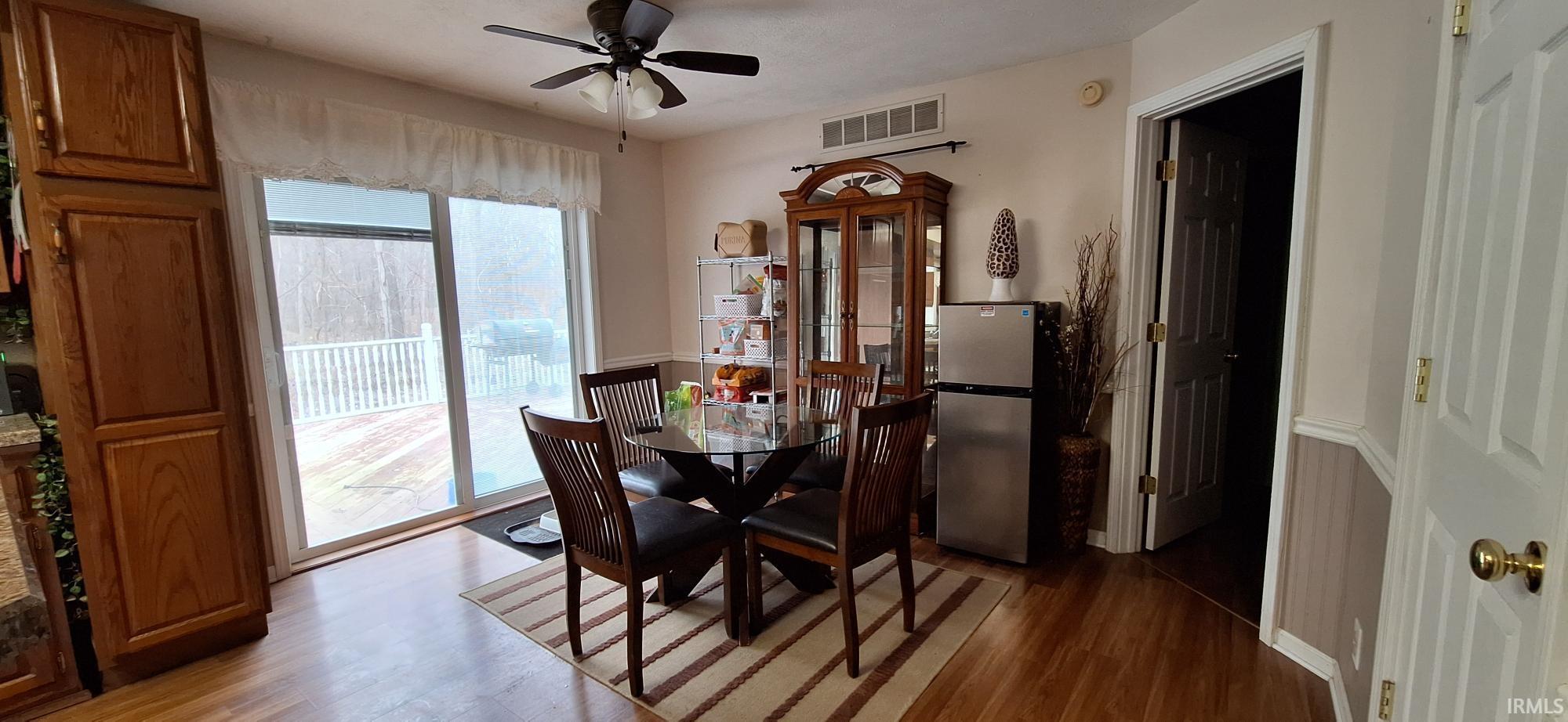 Dining area with light wood-style floors and ceiling fan