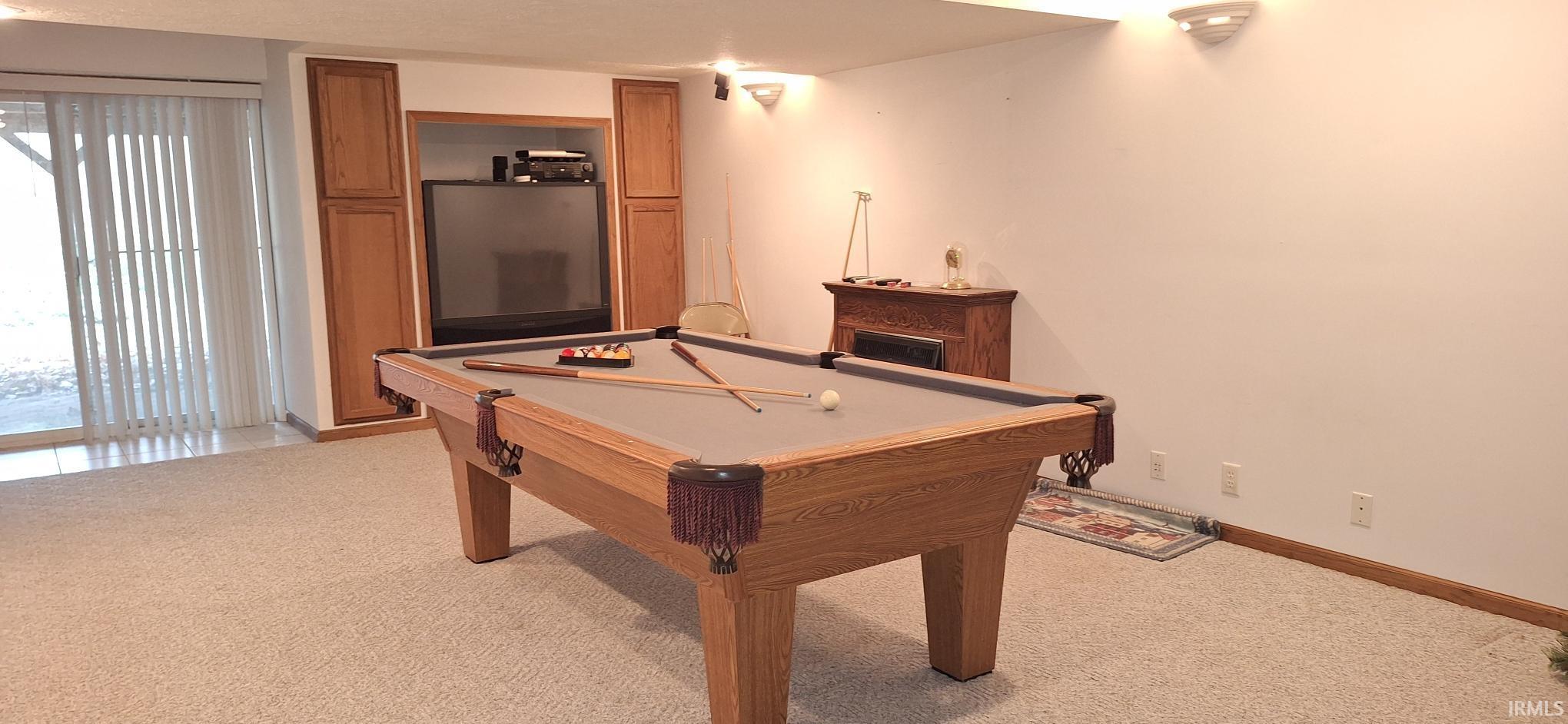 Rec room with billiards table and light colored carpet