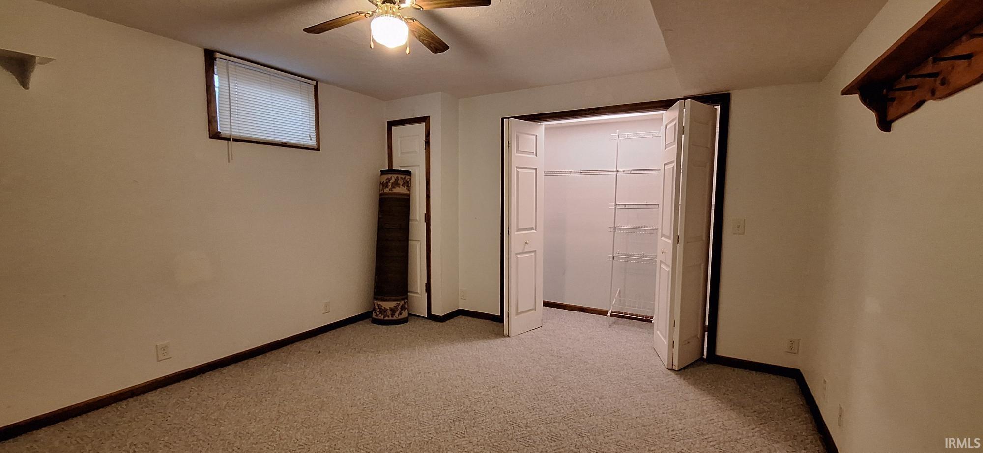 Unfurnished bedroom with light carpet, a closet, and ceiling fan