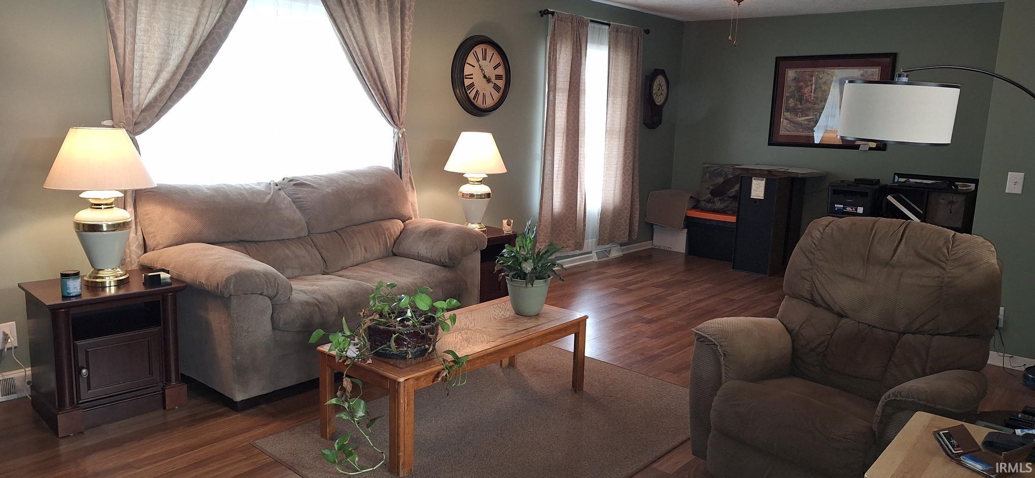Living area featuring wood finished floors and baseboards