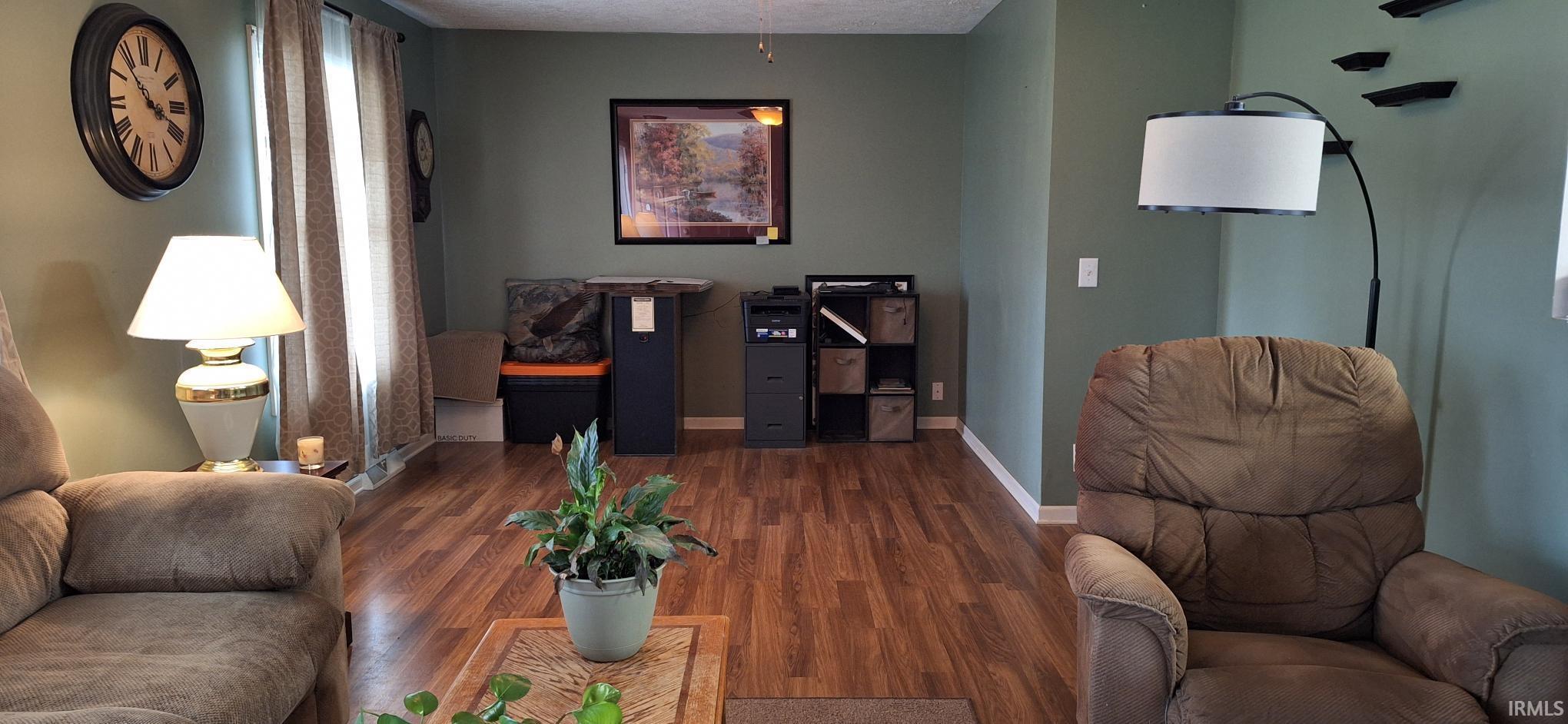 Living room featuring baseboards and wood finished floors