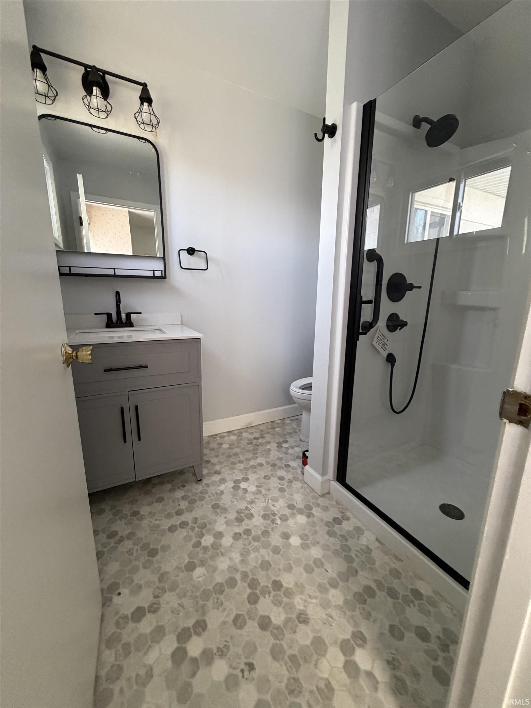 Bathroom featuring vanity and a stall shower
