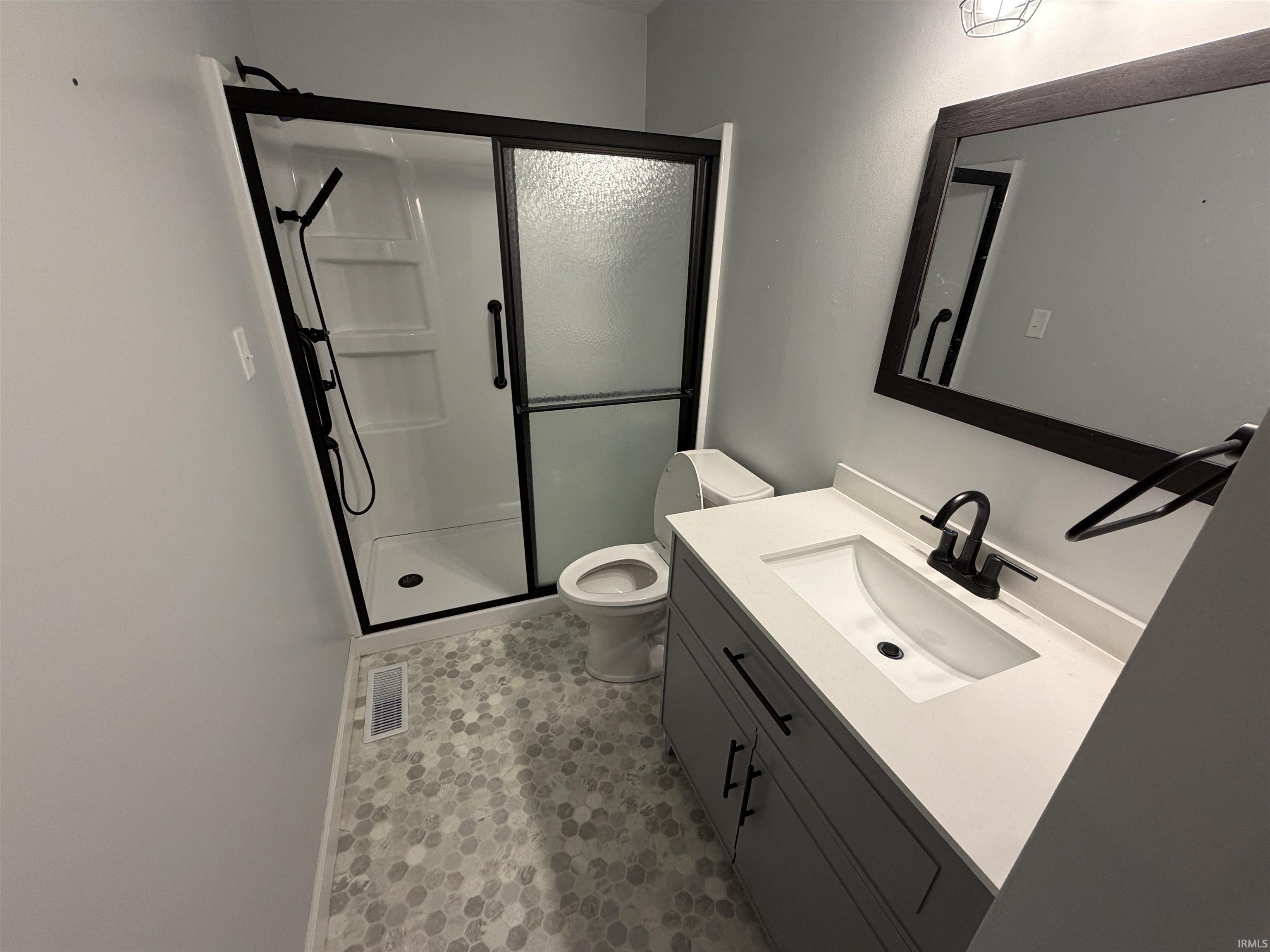 Bathroom with vanity and a shower stall