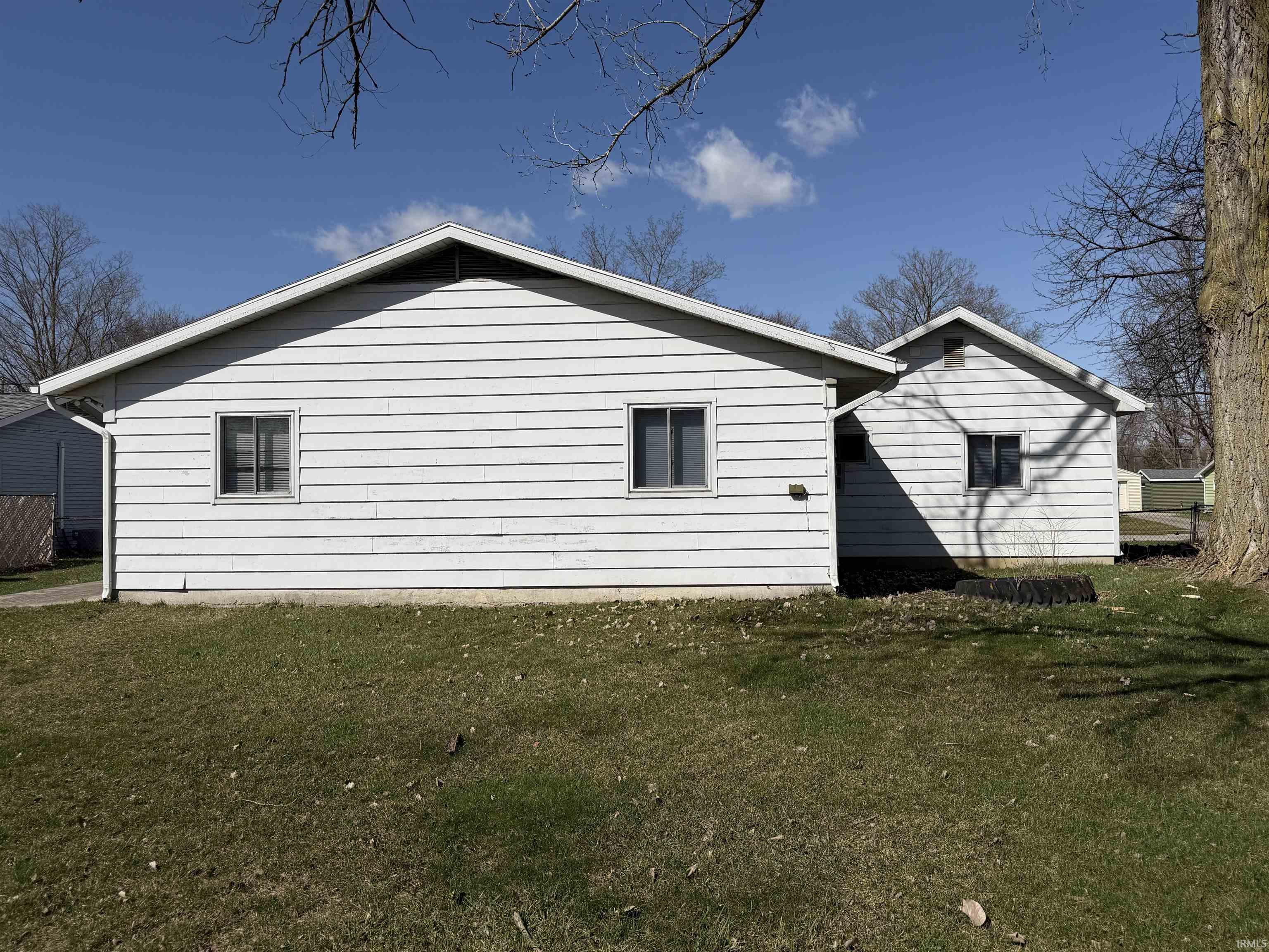 View of property exterior with a lawn