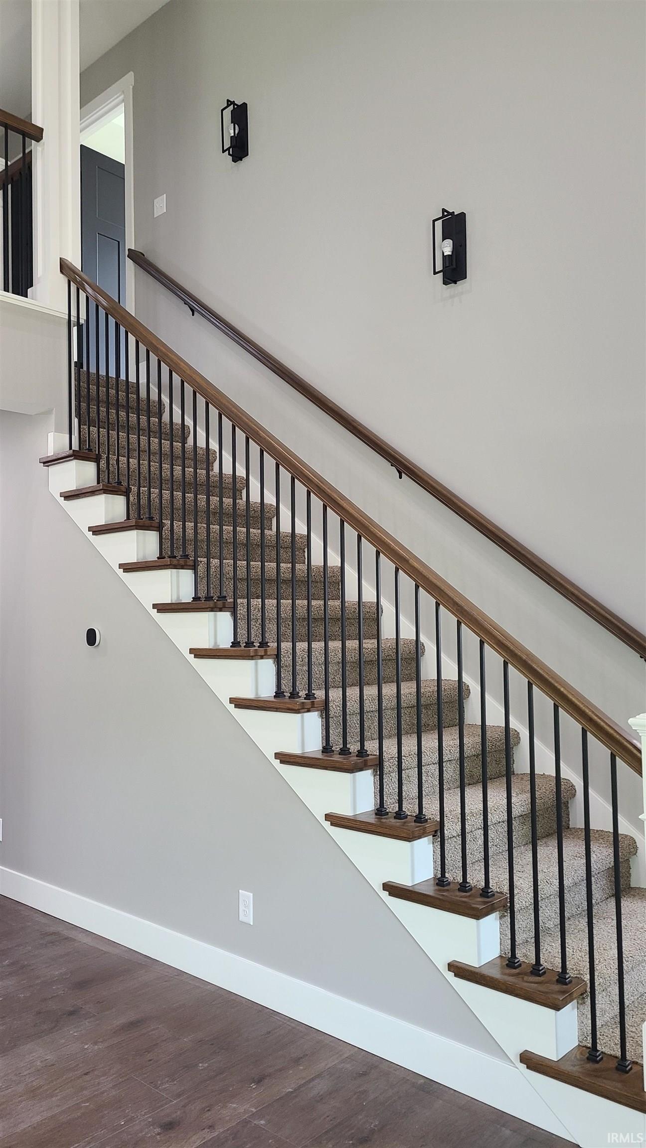 Stairway with baseboards and wood finished floors
