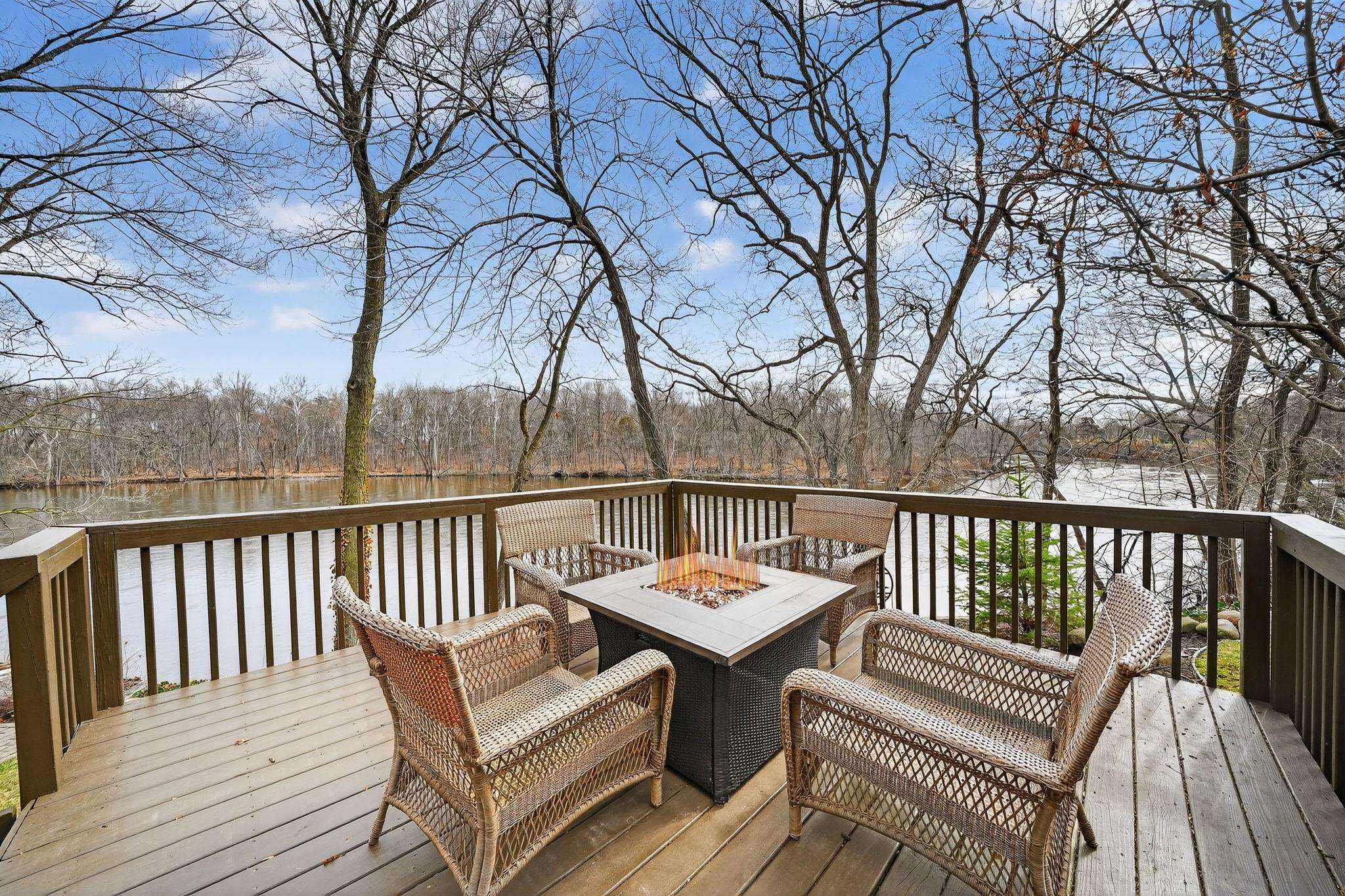Wooden terrace with a water view and a fire pit