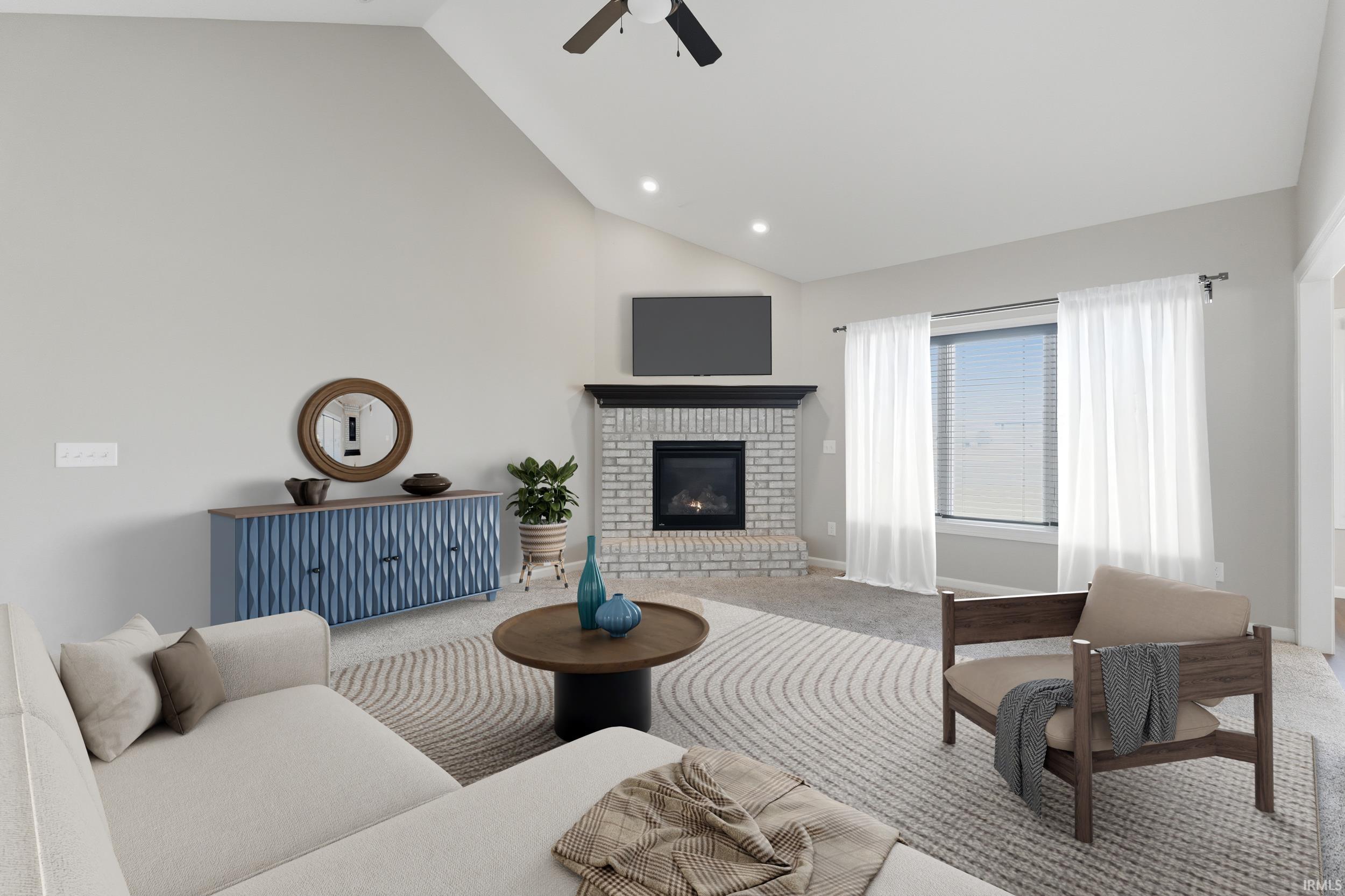 Carpeted living room featuring a ceiling fan, a fireplace, lofted ceiling, and recessed lighting