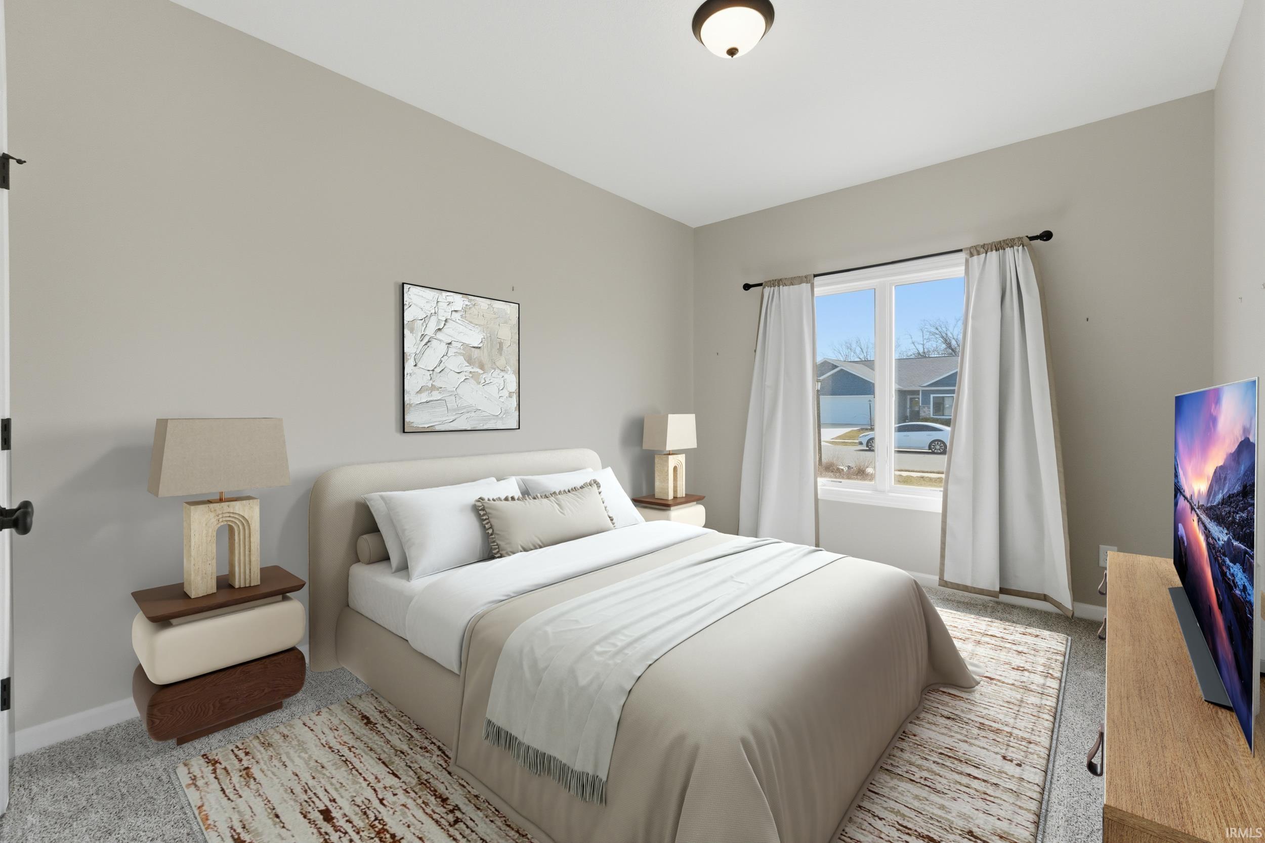 Bedroom featuring light colored carpet