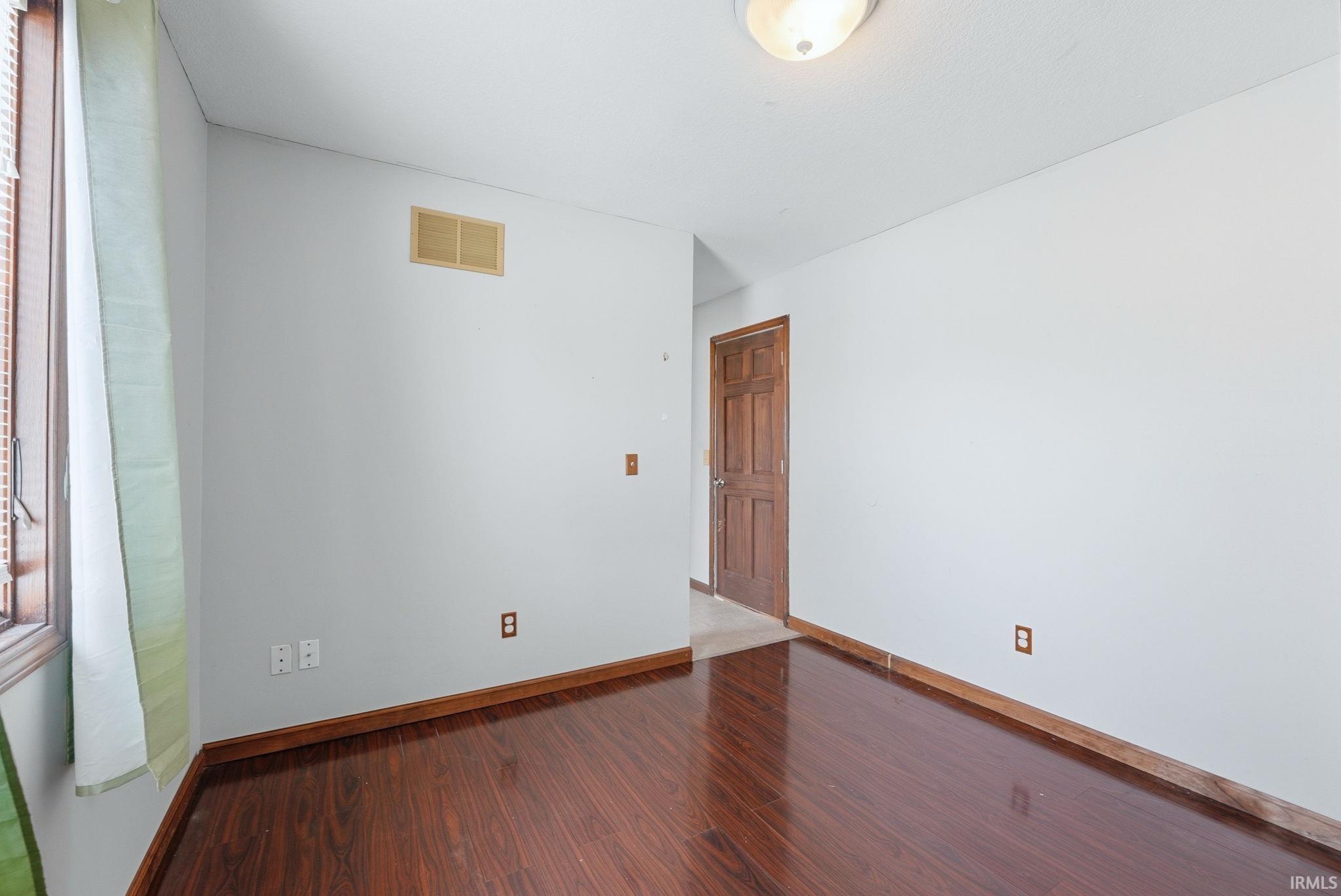Empty room with wood finished floors and baseboards