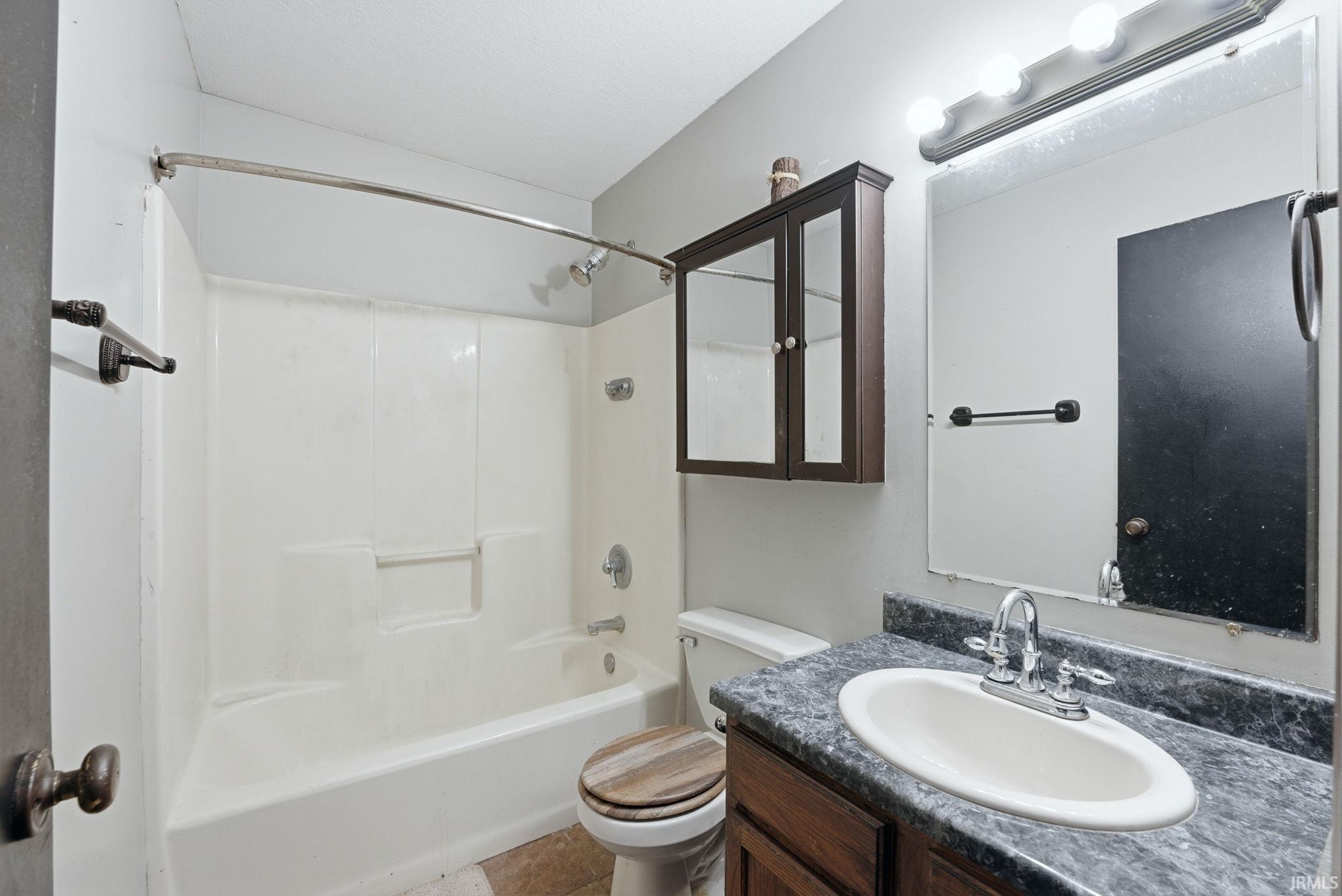 Bathroom with vanity and tub / shower combination