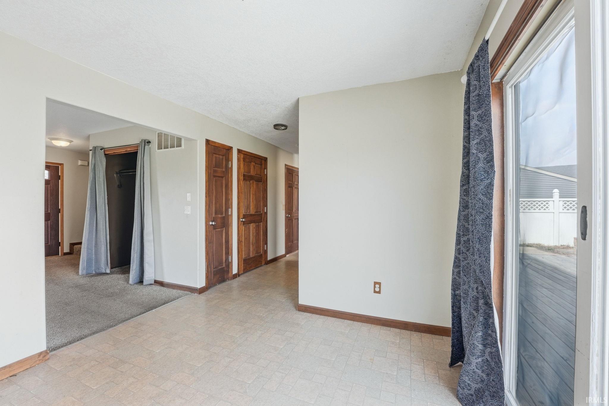 Spare room featuring baseboards