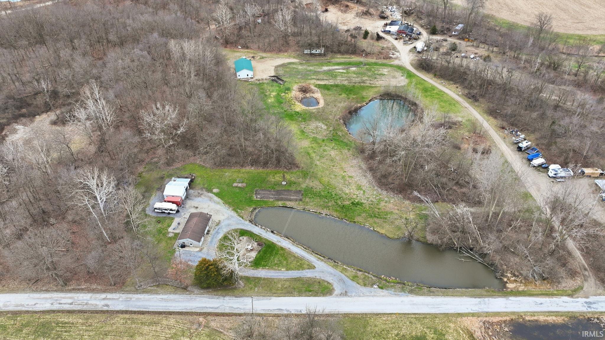 Aerial view of property's location featuring a large body of water