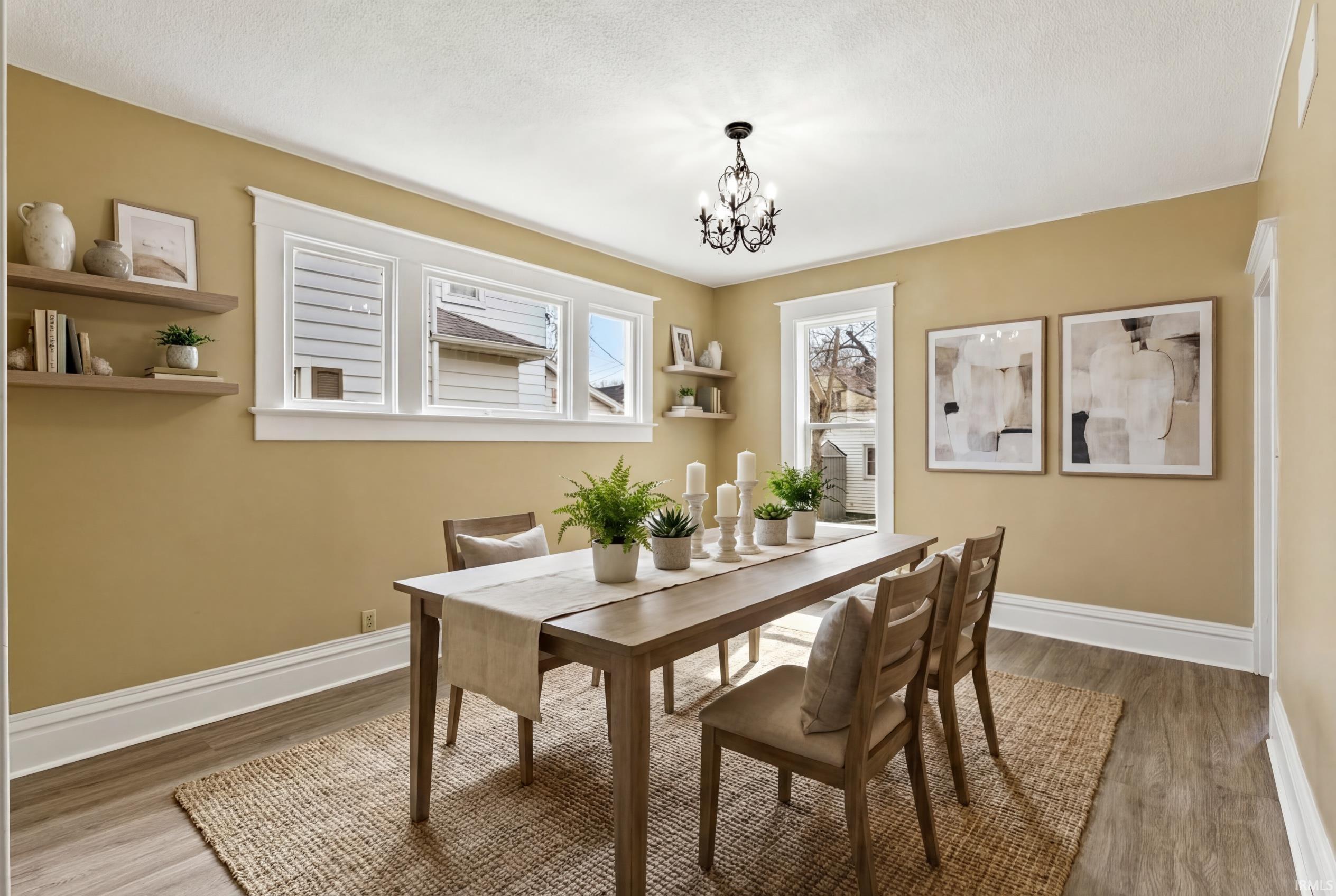 Dining room with hanging lights and light wood-type flooring
