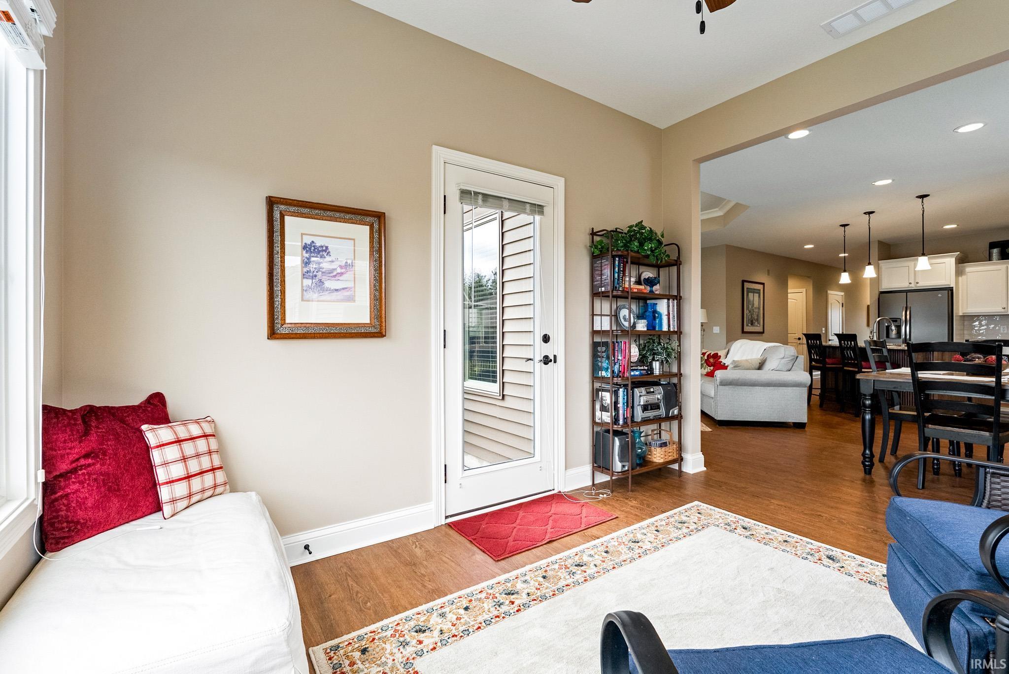 Living area with recessed lighting, wood finished floors, and a ceiling fan